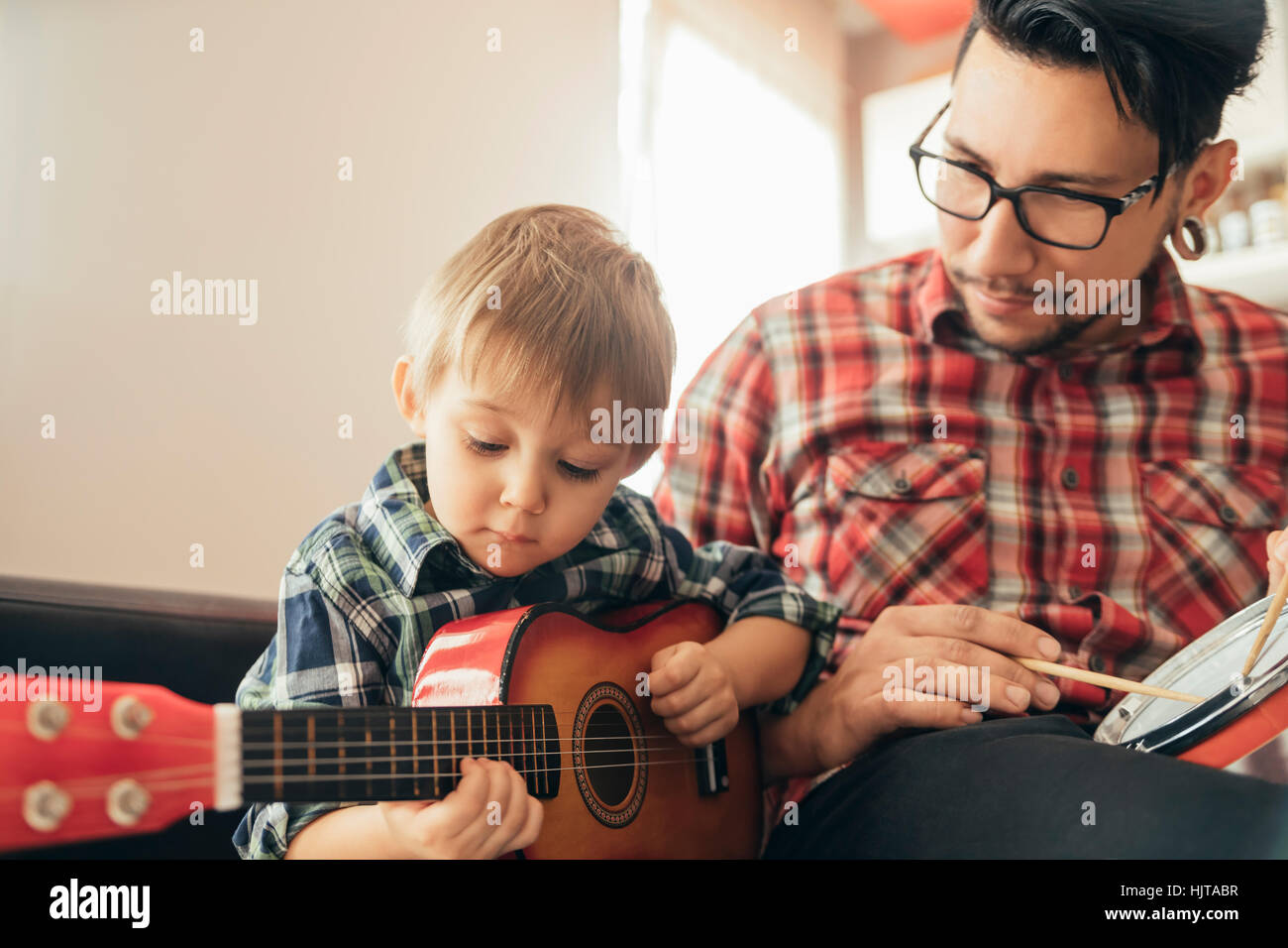 Father and son playing toy musical instruments Stock Photo - Alamy