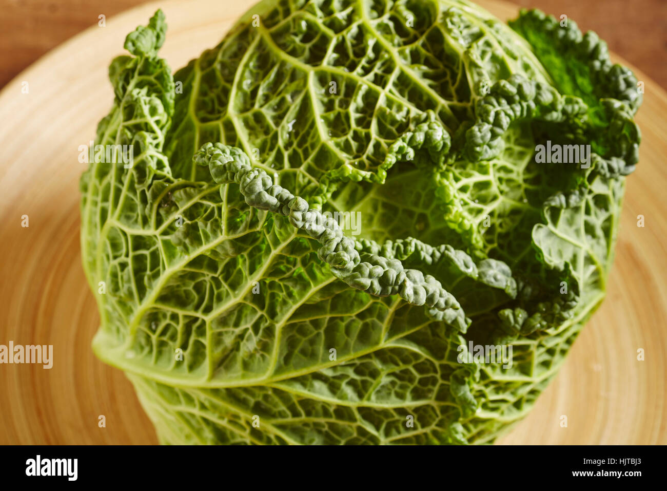 a whole head of raw savoy cabbage Stock Photo Alamy