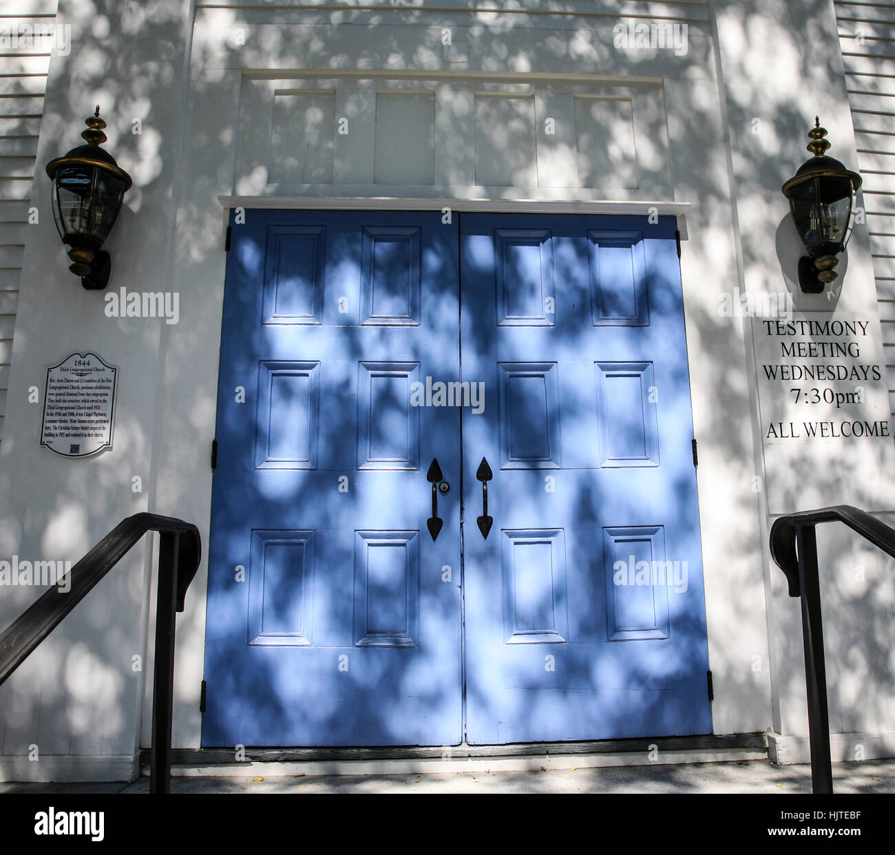 A close up church with light blue front doors with shadows, parish Pantone Blue exterior Stock Photo