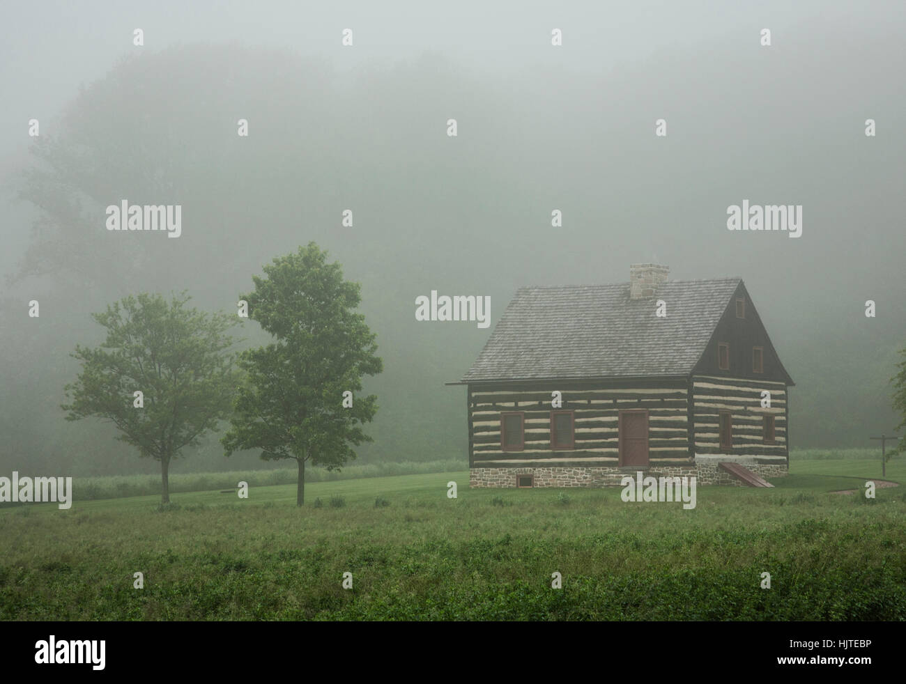 Historic Log cabin country farmhouse in the fog, Lancaster County, rural Pennsylvania, USA, US