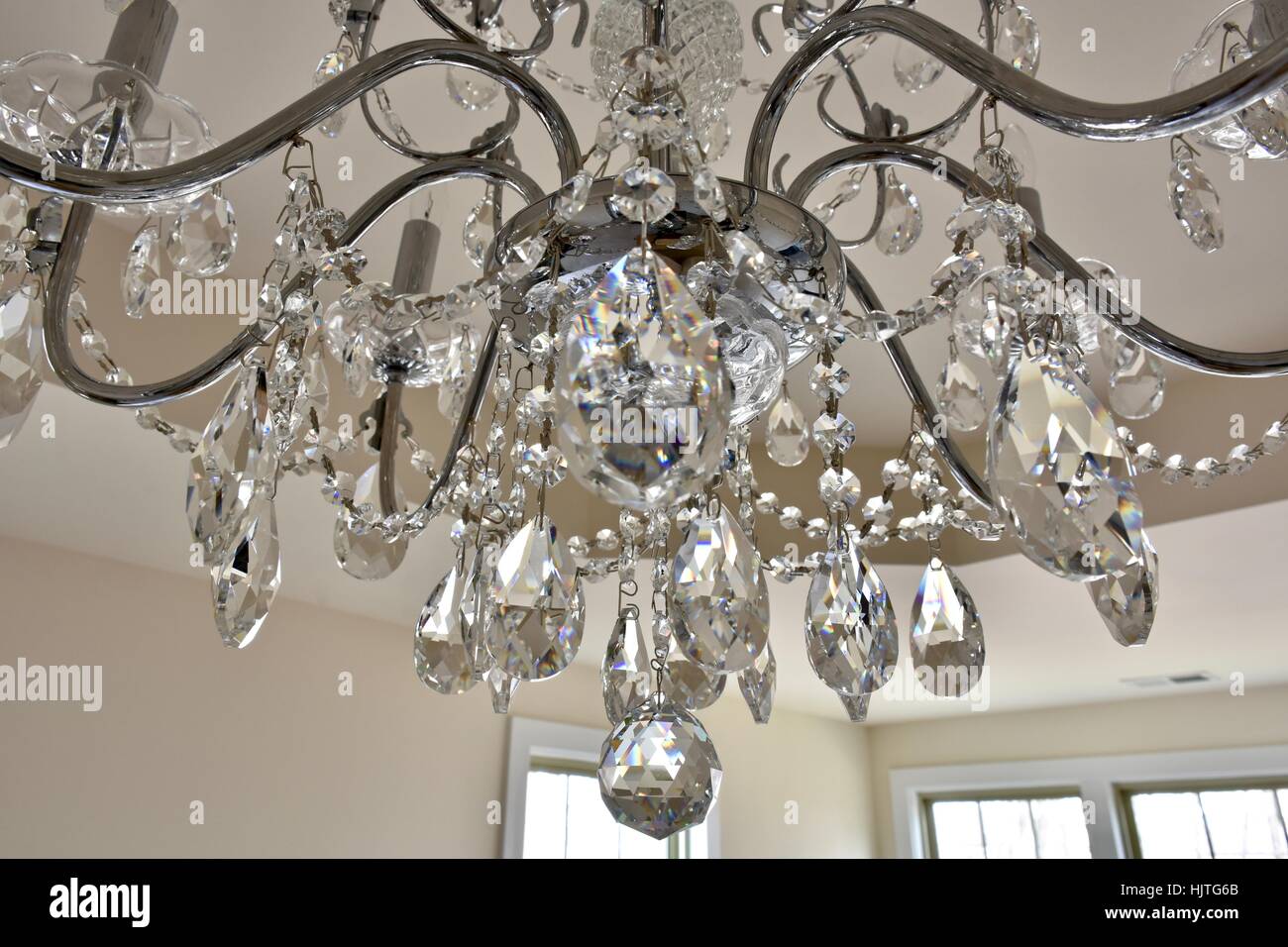 Crystal chandelier hanging from the ceiling of a master bedroom Stock