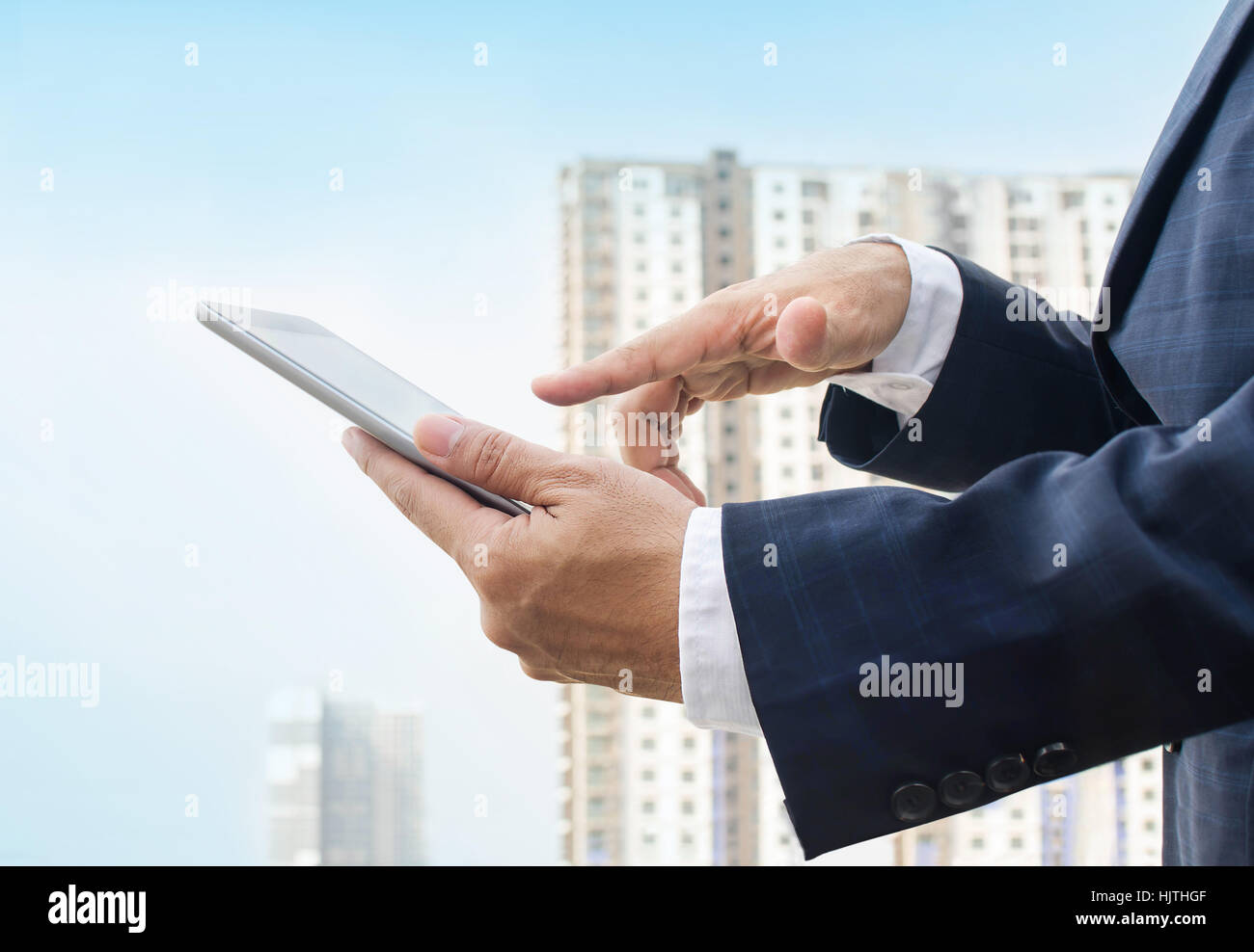 Hands of a businessman holding digital tablet Stock Photo