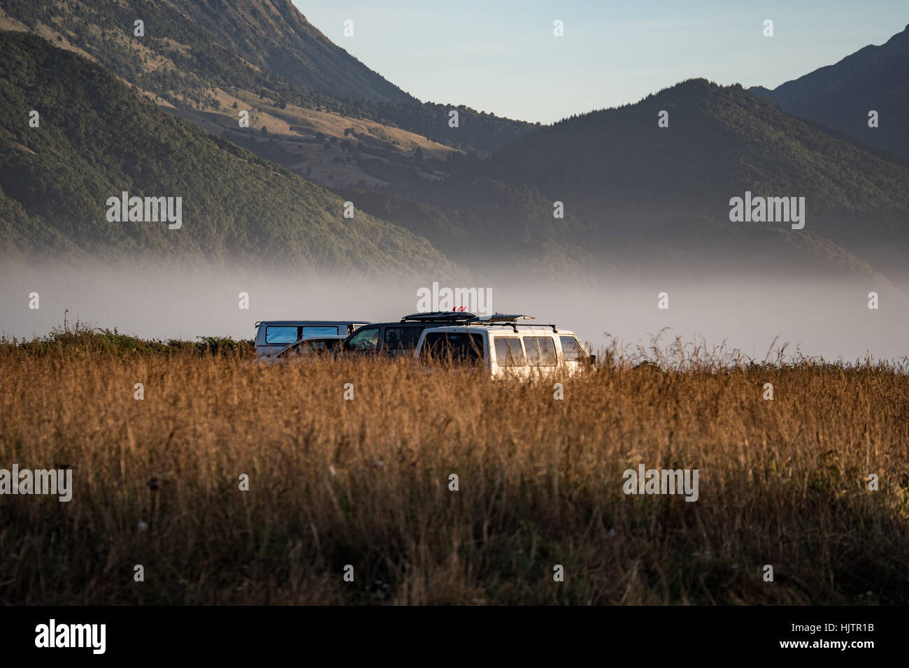 Camper vans wild camping on beach near Kaikoura.  South Island, New Zealand. Stock Photo