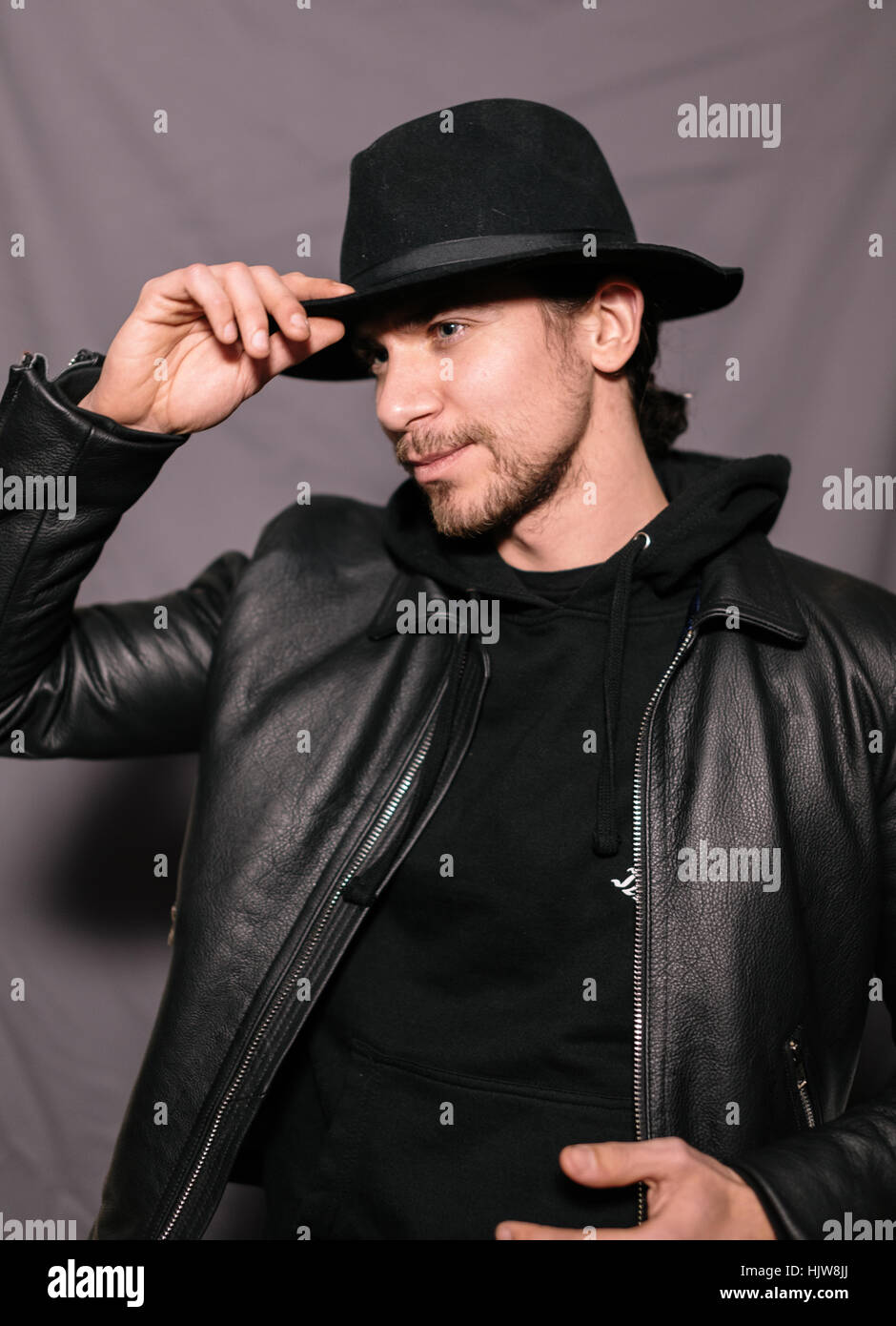 guy in a hat and leather jacket Stock Photo - Alamy