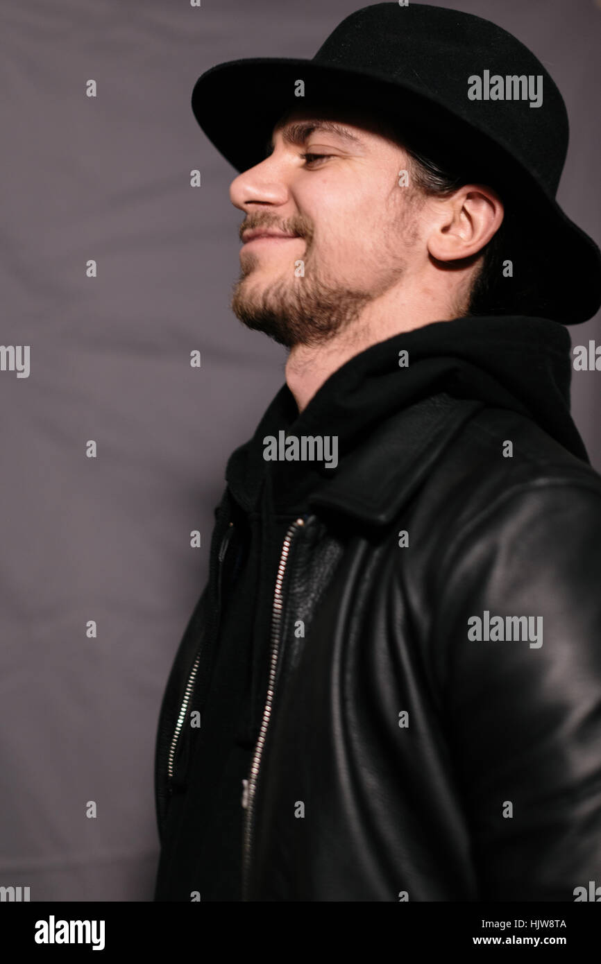guy in a hat and leather jacket Stock Photo - Alamy