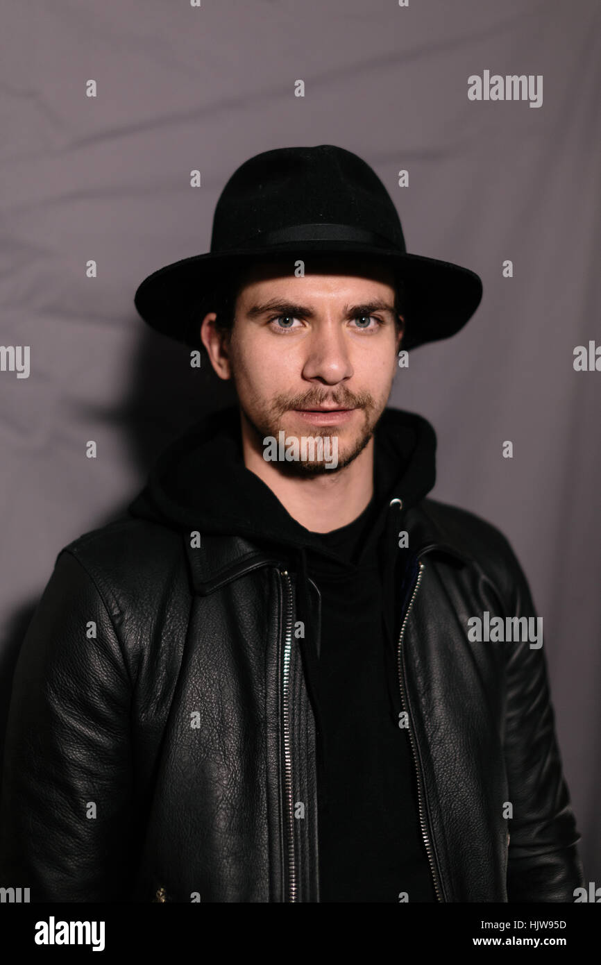 guy in a hat and leather jacket Stock Photo - Alamy