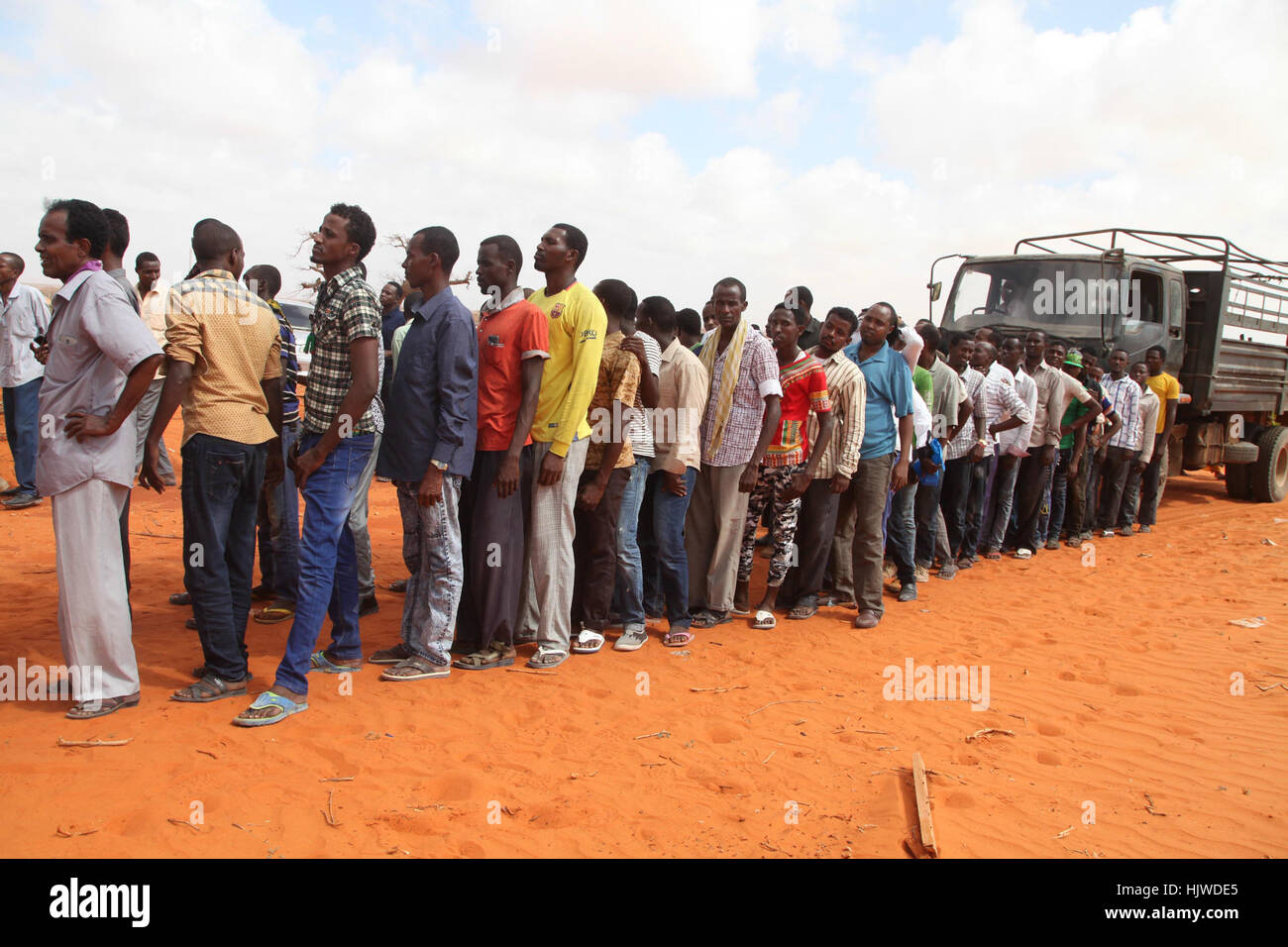 New recruits for the Interim Jubbaland Administration (IJA) line up for a security check at Kismayo Police Training School during vetting exercise in Somalia on December 21, 2016.  Barut Mohamed Stock Photo