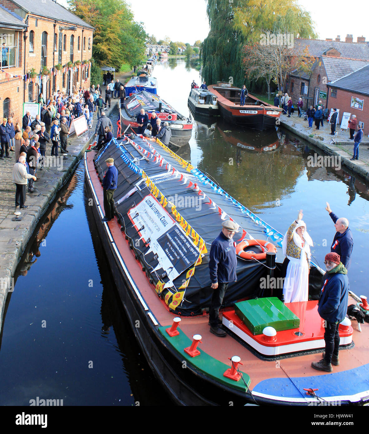 A boat that was part of the flotilla commemorating the of the opening of the Leeds and Liverpool canal leaves Burscough. Stock Photo