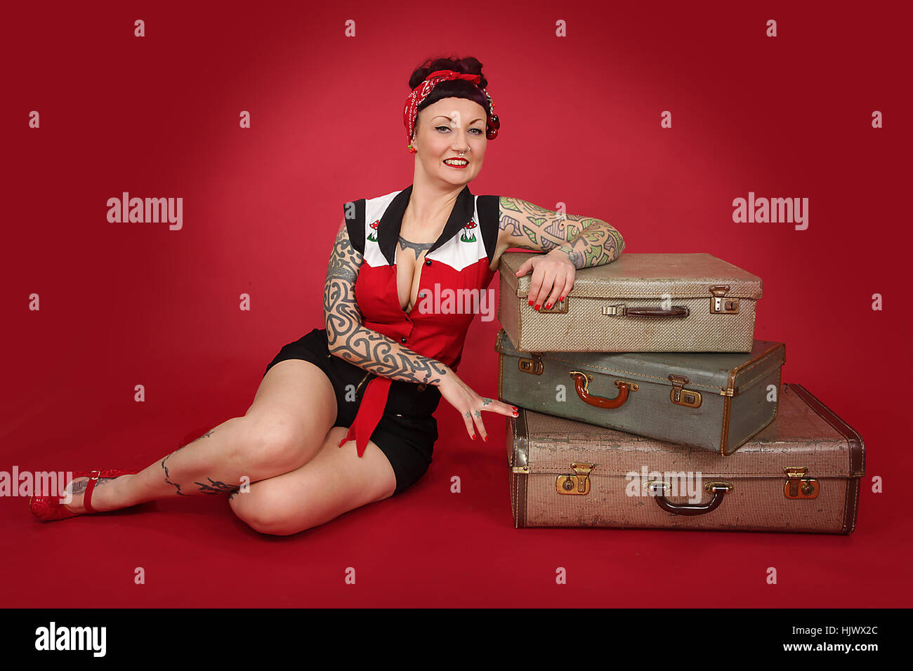 Female woman dressed in a rockabilly fashion posing next to a classic  vehicle Stock Photo - Alamy