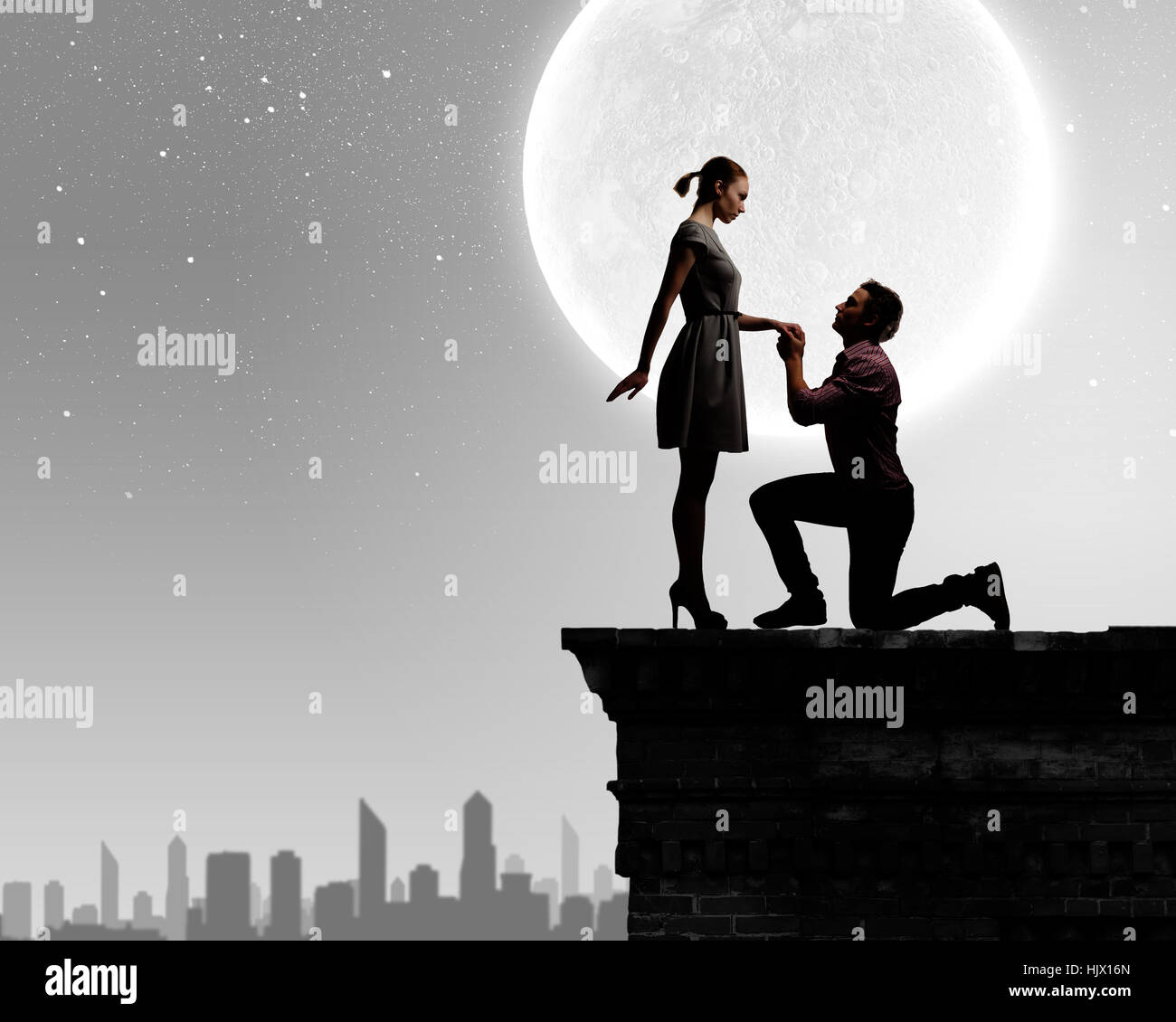 Silhouettes of romantic couple under the moon light Stock Photo - Alamy
