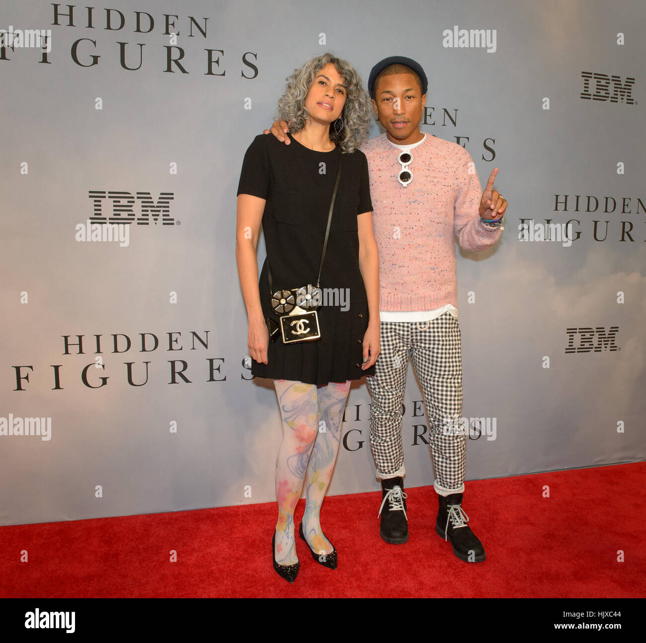 Producer Mimi Valdés and American singer-songwriter Pharrell Williams arrive on the red carpet for the global celebration of the film &quot;Hidden Figures&quot; at the SVA Theatre, Saturday, Dec. 10, 2016 in New York. The film is based on the book of the same title, by Margot Lee Shetterly, and chronicles the lives of Katherine Johnson, Dorothy Vaughan and Mary Jackson -- African-American women working at NASA as “human computers,” who were critical to the success of John Glenn’s Friendship 7 mission in 1962. Stock Photo