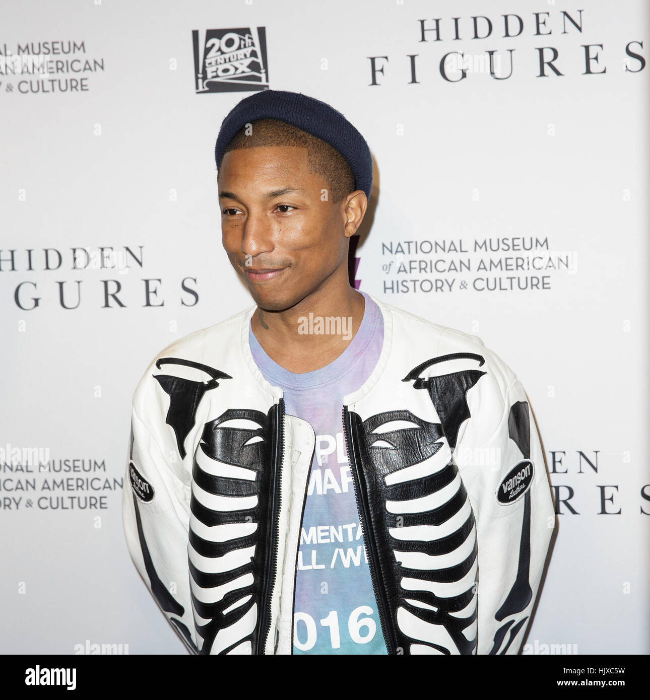 American singer-songwriter Pharrell Williams arrives on the red carpet for a screening of the film “Hidden Figures” at the Smithsonian’s National Museum of African American History and Culture, Wednesday, Dec. 14, 2016 in Washington DC. The film is based on the book of the same title, by Margot Lee Shetterly, and chronicles the lives of Katherine Johnson, Dorothy Vaughan and Mary Jackson -- African-American women working at NASA as “human computers,” who were critical to the success of John Glenn’s Friendship 7 mission in 1962. Stock Photo