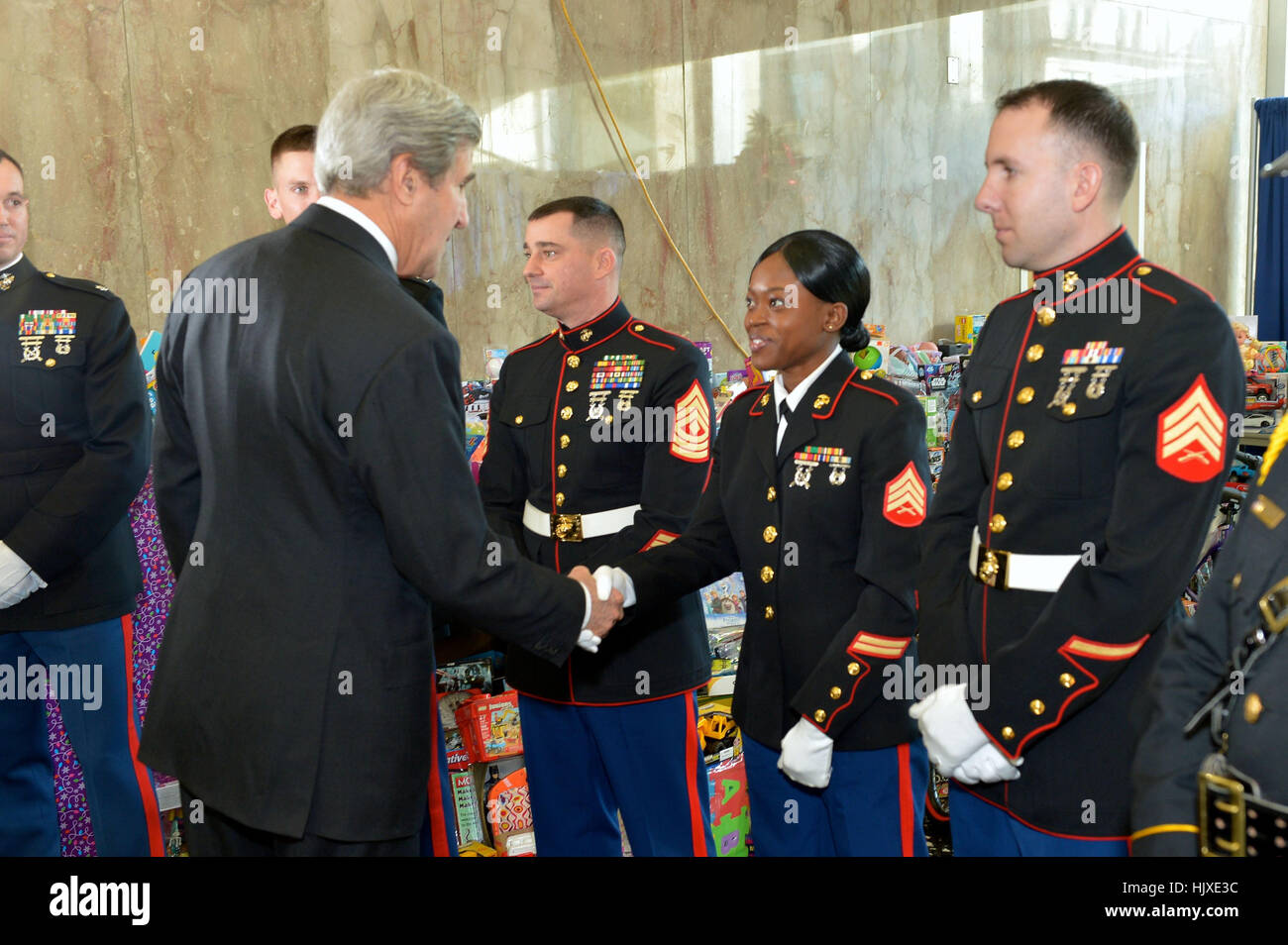 U.S. Secretary of State John Kerry greets U.S. Marines at the Toys for Tots ceremonial presentation to the Marine Corps Reserve, at the U.S. Department of State in Washington, D.C., on December 14, 2016. Stock Photo