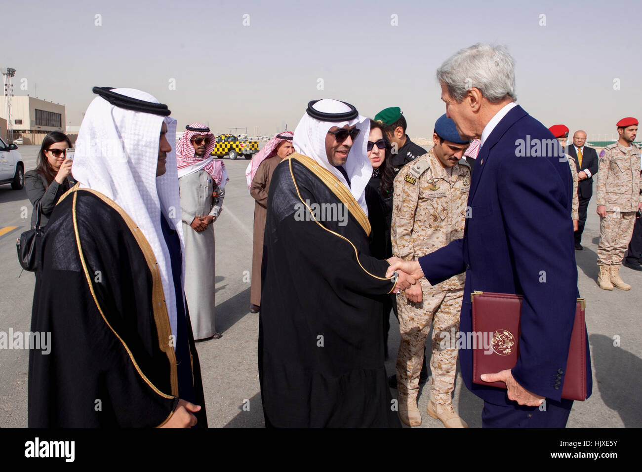 Saudi Arabia Ministry of Foreign Affairs Protocol Representative Saad Al Sebaie greets U.S. Secretary of State John Kerry at King Salman Airbase in Riyadh, Saudi Arabia, after he arrived on December 18, 2016, for meetings focused on Yemen. Stock Photo