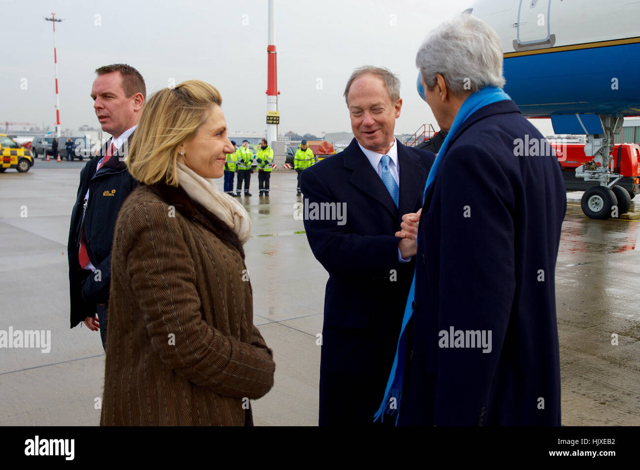 U.S. Secretary of State John Kerry speaks with U.S. Ambassador to Germany John Emerson and his wife, Kimberly, on December 7, 2016, as he arrives in Hamburg, Germany, to attend a meeting of the Organization for Security and Co-operation in Europe. Stock Photo