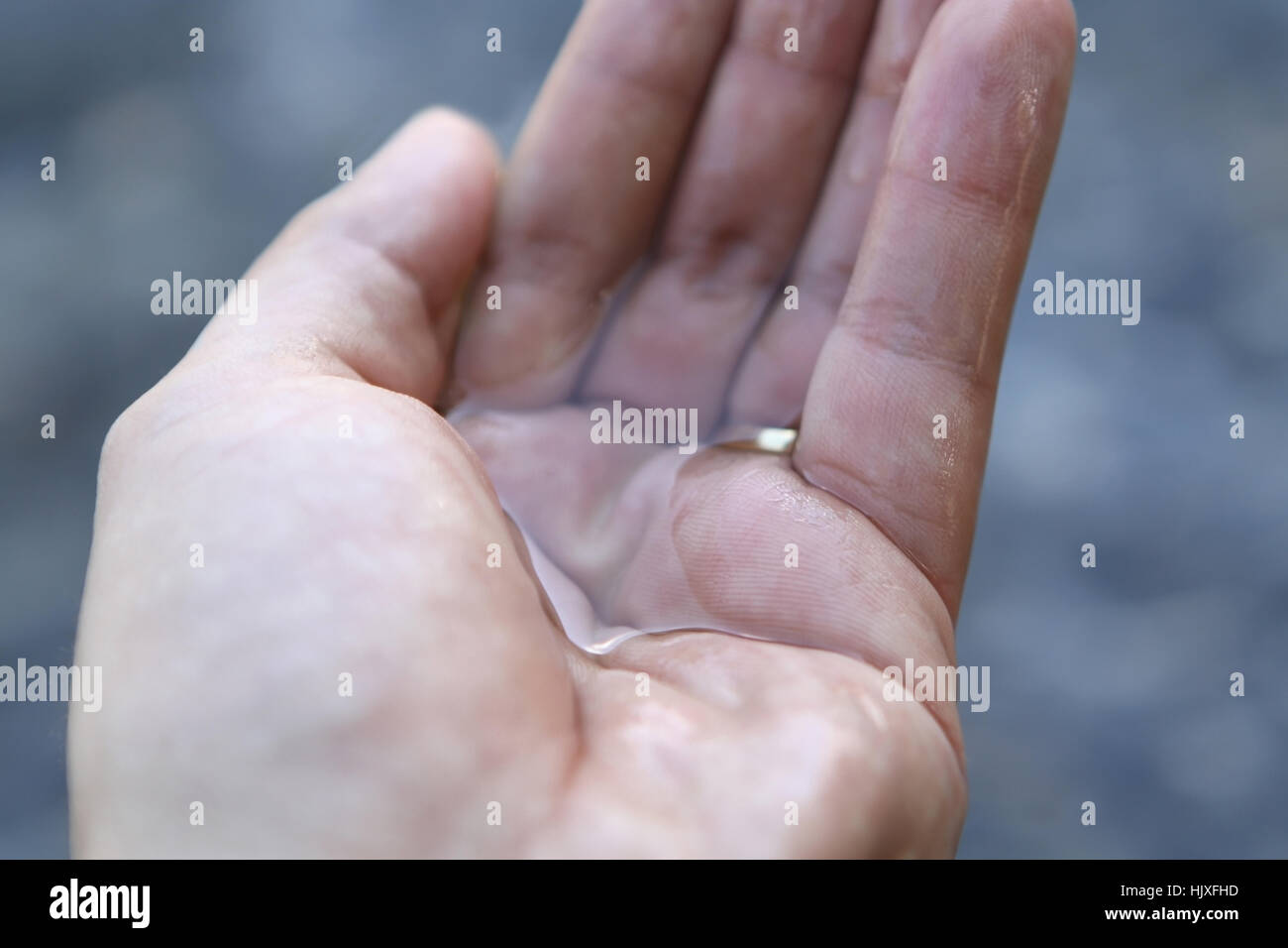 Female Hand Holding Water Stock Photo
