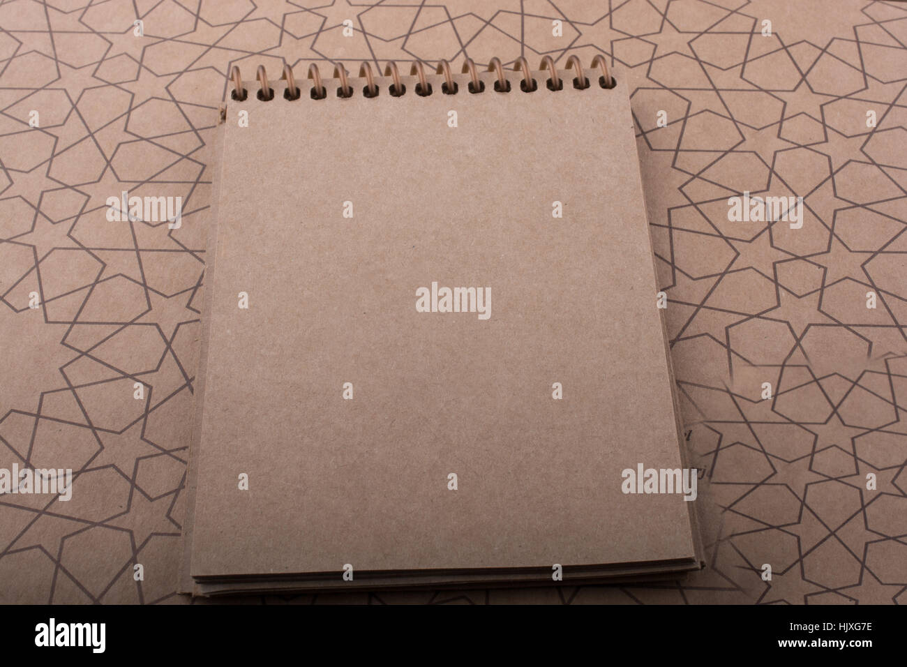 Spiral notebook placed on a straw background Stock Photo - Alamy