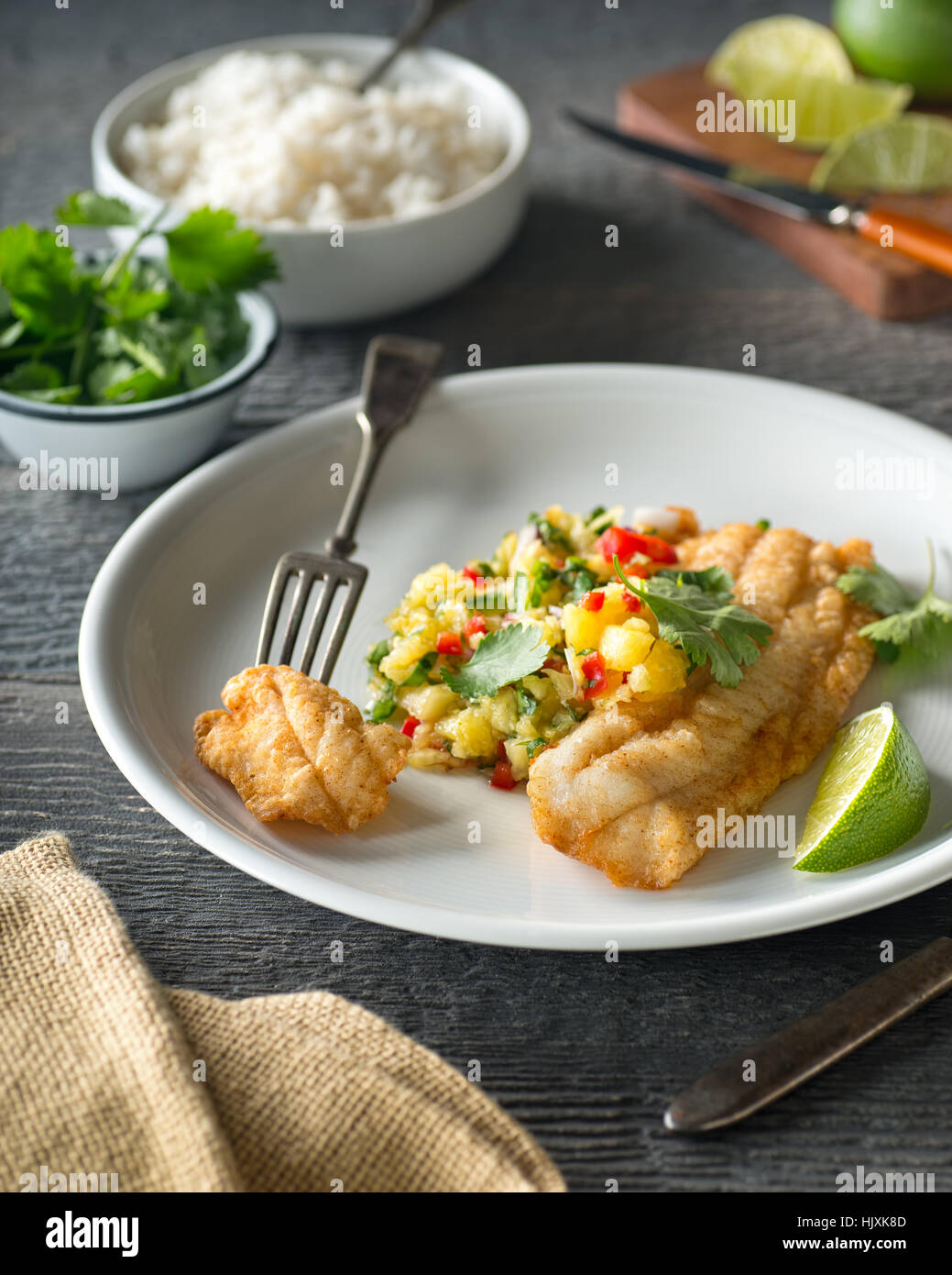 Delicious sauteed fish with pineapple jalapeno salsa and lime. Stock Photo