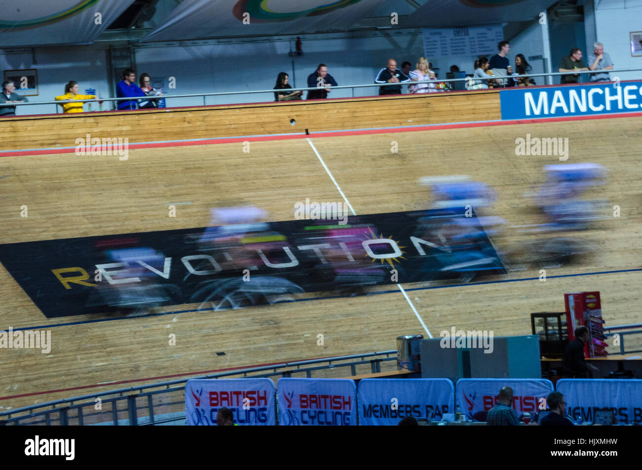 A motion blur of cyclists as they race at the National Indoor Championships at Manchester's velodrome Stock Photo