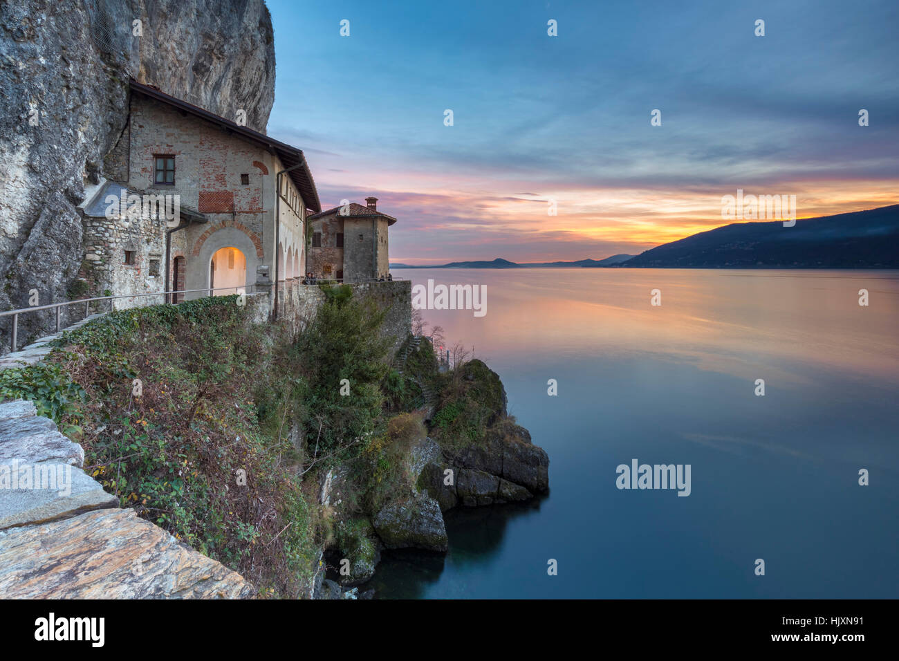 Sunset in front of the old monastery of Santa Caterina del Sasso Ballaro, overlooking Lake Maggiore, Leggiuno, Varese Province, Stock Photo