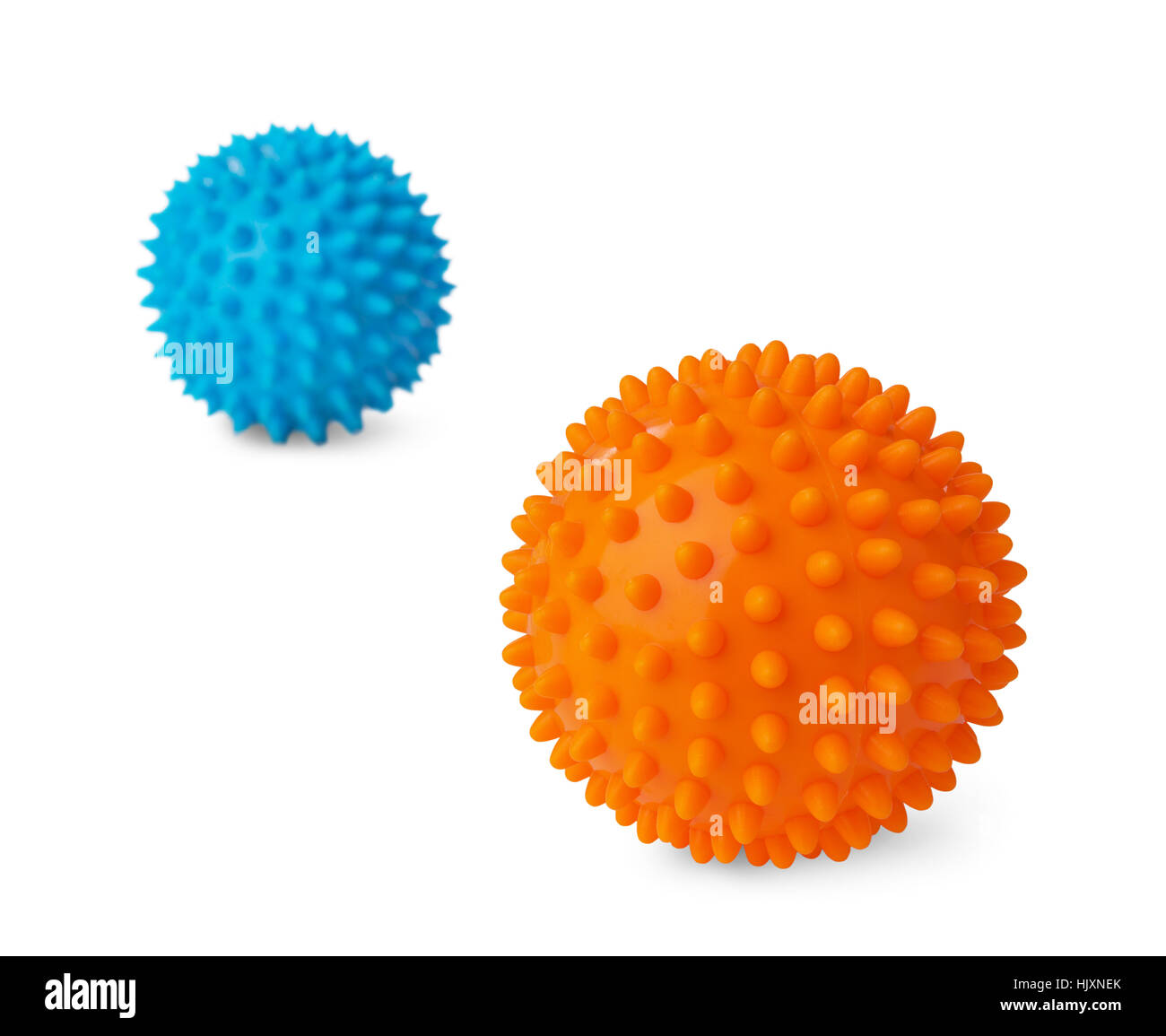 Two spiny plastic orange and blue massage balls isolated on white background. Focus on the orange ball Stock Photo
