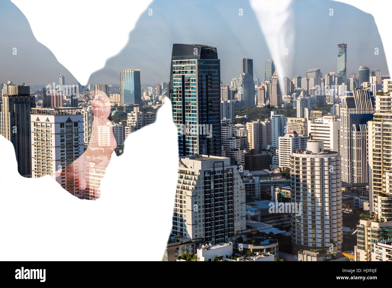 Double exposure of handshake, city and building Stock Photo