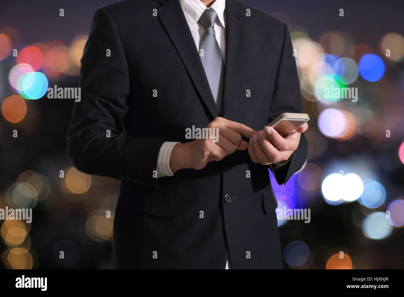 Business man hand hold and touch screen smart phone, mobile on blurred ...
