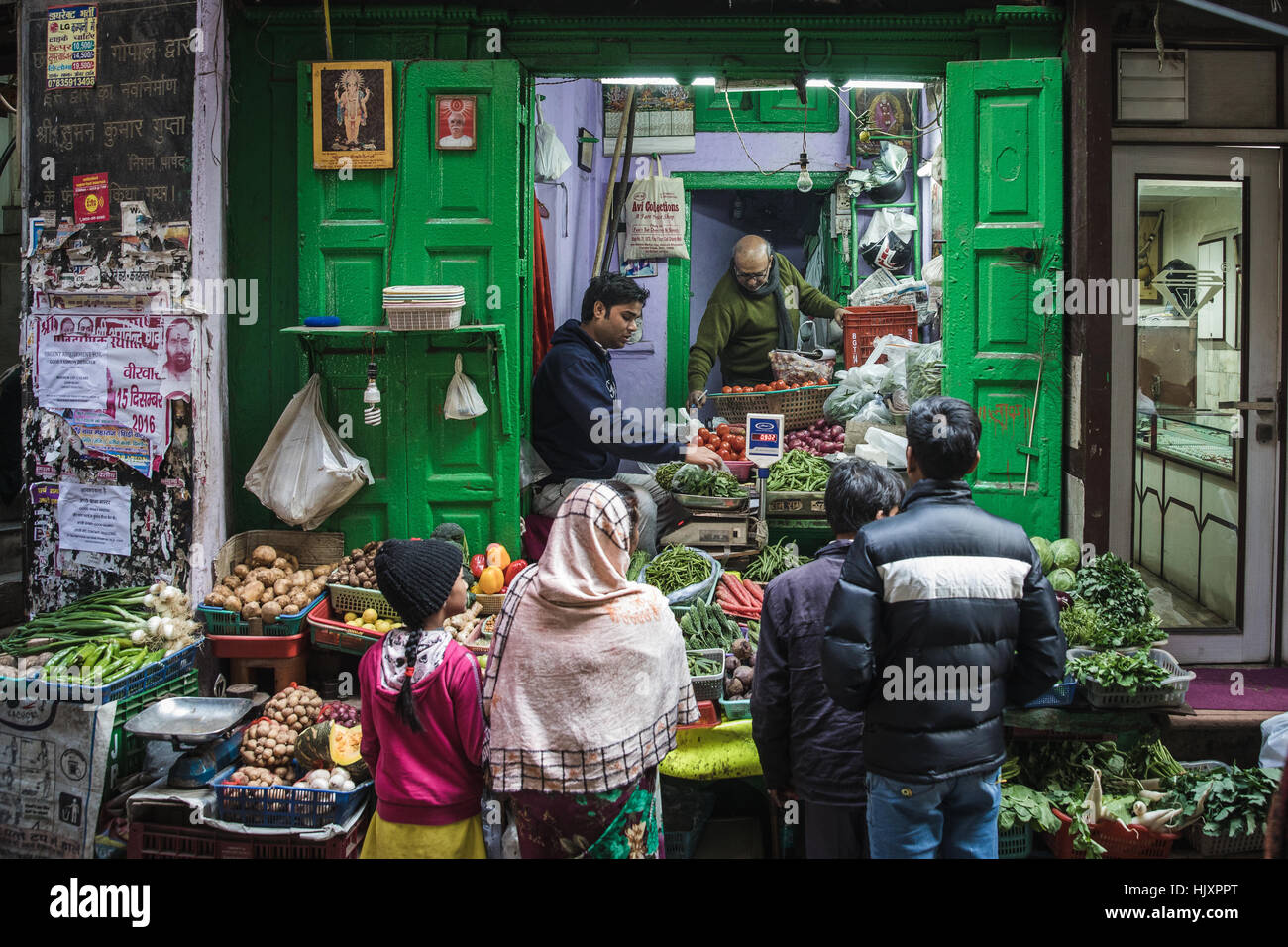 People buying groceries from a fruit and vegetable seller in Chandni Chowk, New Delhi, India. Stock Photo