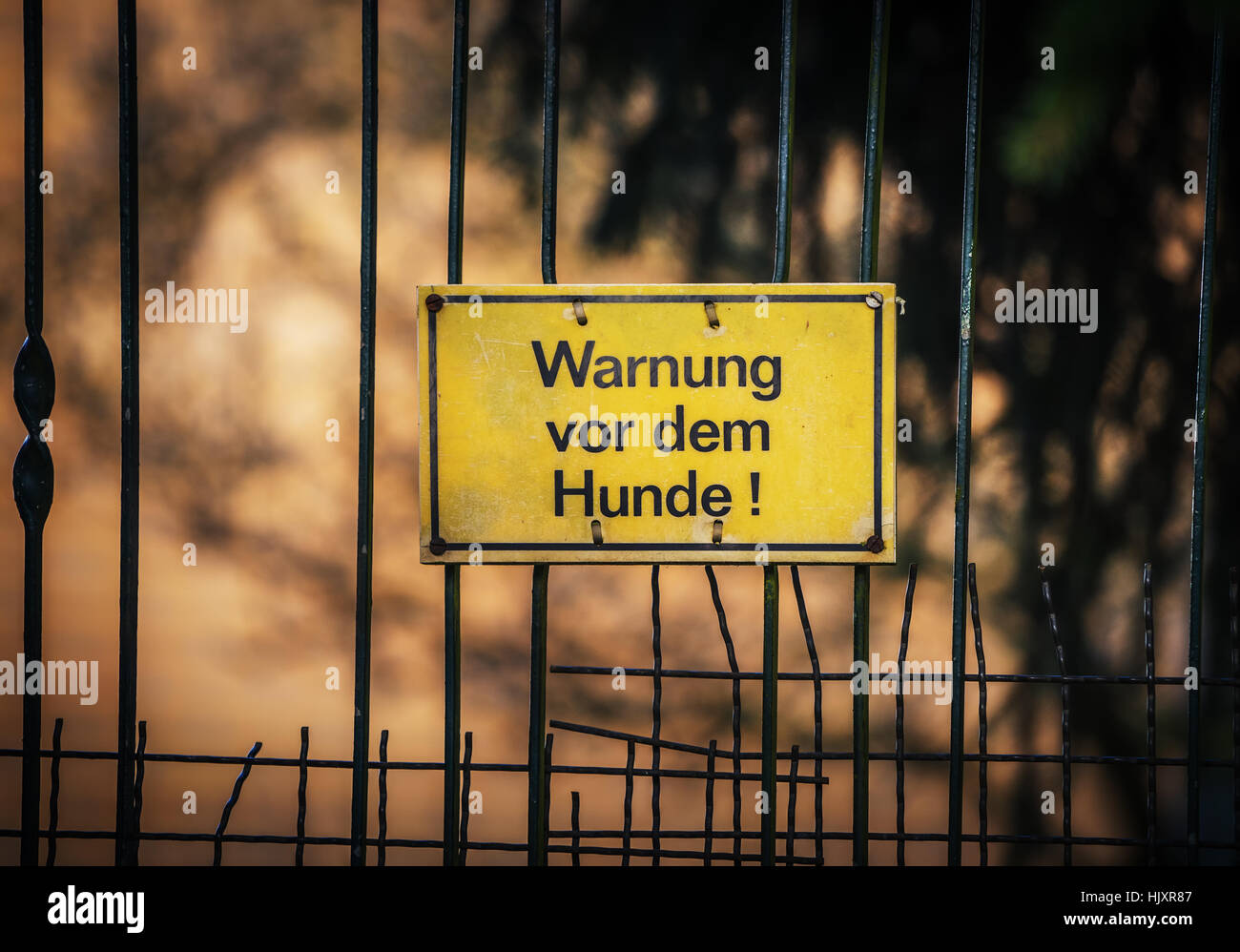 German warning sign hanging on the fence Stock Photo