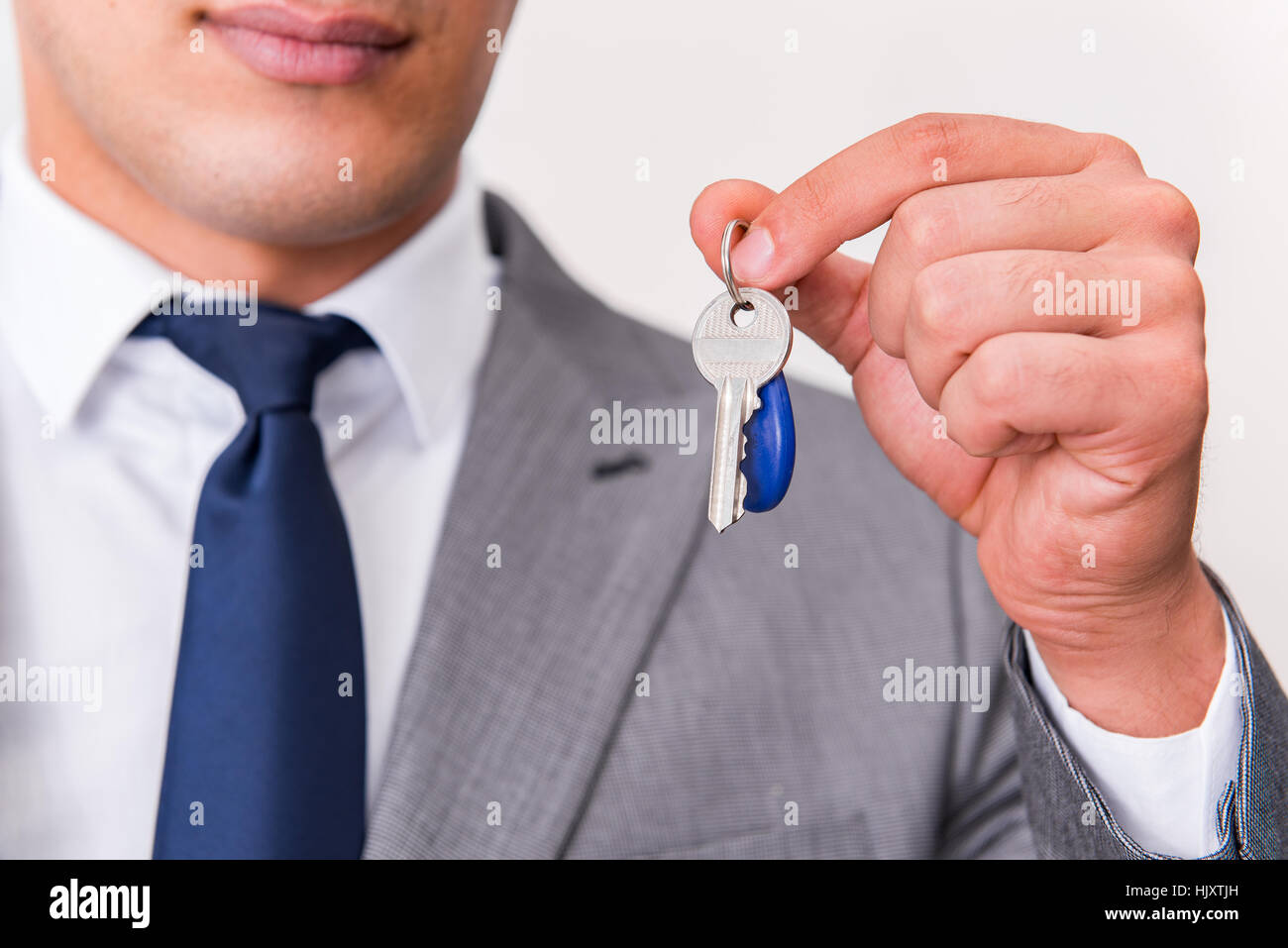 Businessman in real estate concept with home key Stock Photo - Alamy