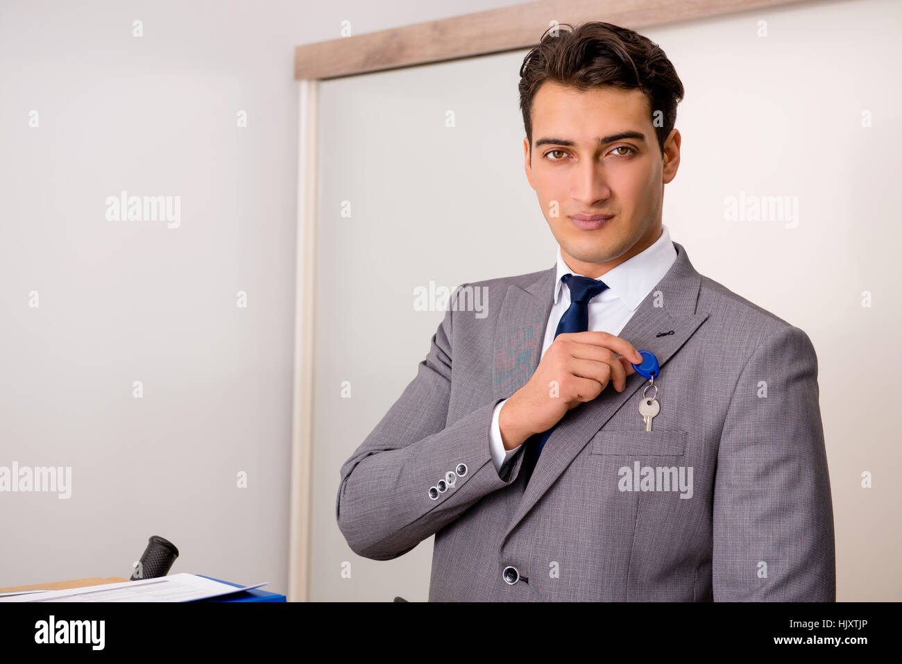 Businessman in real estate concept with home key Stock Photo - Alamy