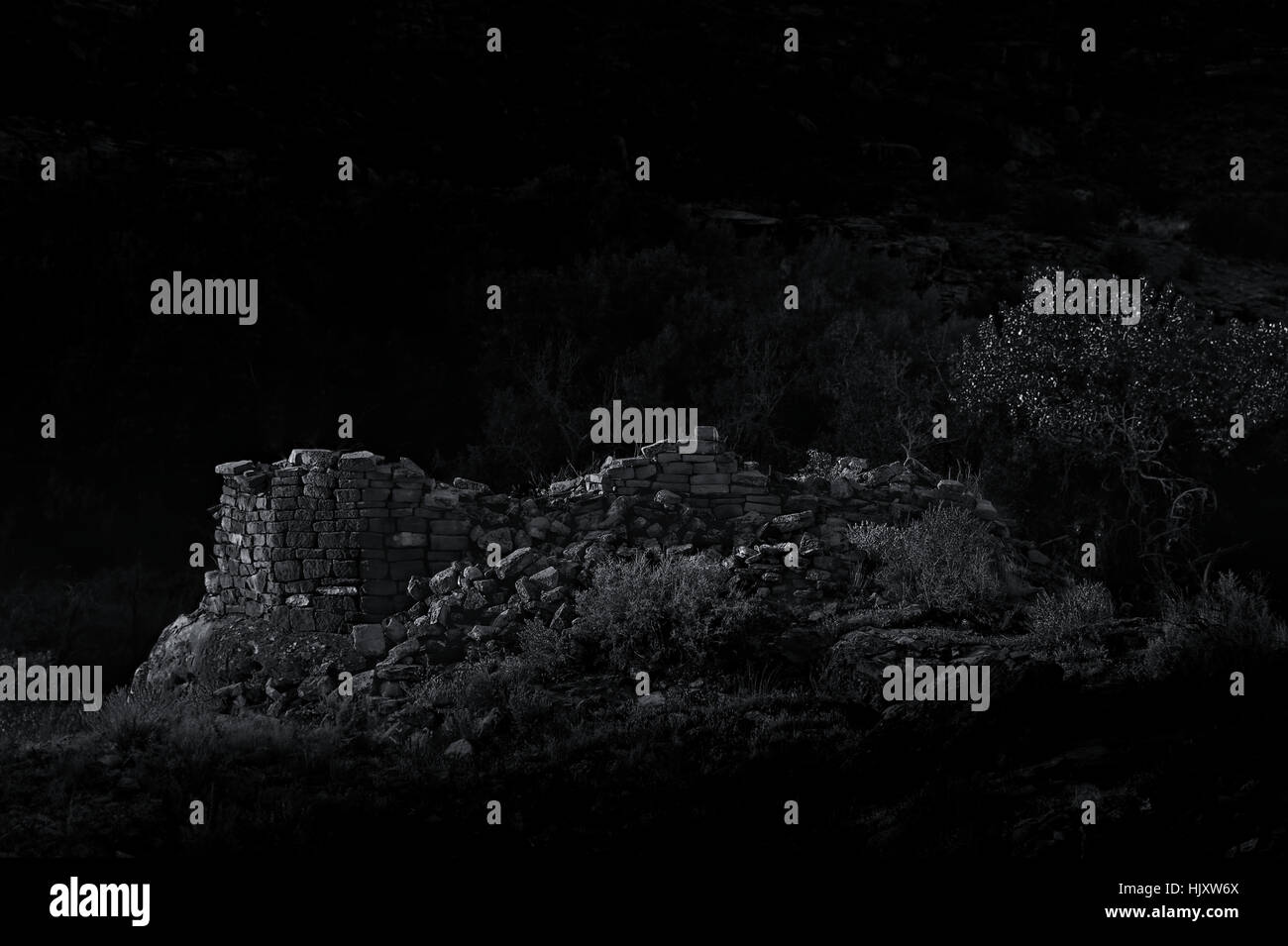 Dramatic B&W photo of a fallen Anasazi tower in the moonlight. Stock Photo