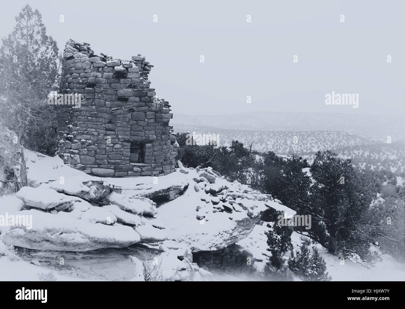 Painted Hand Tower, an Anasazi ruin, overlooking Hovenweep Canyon during a snow storm. Black and white photograph. Stock Photo