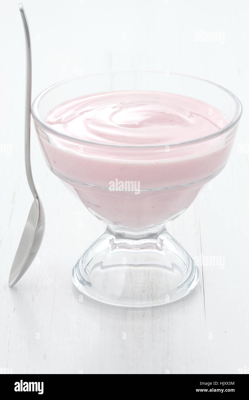 Fresh, healthy and delicious creamy, strawberry yogurt in vintage French cup, the perfect snack or dessert. Stock Photo