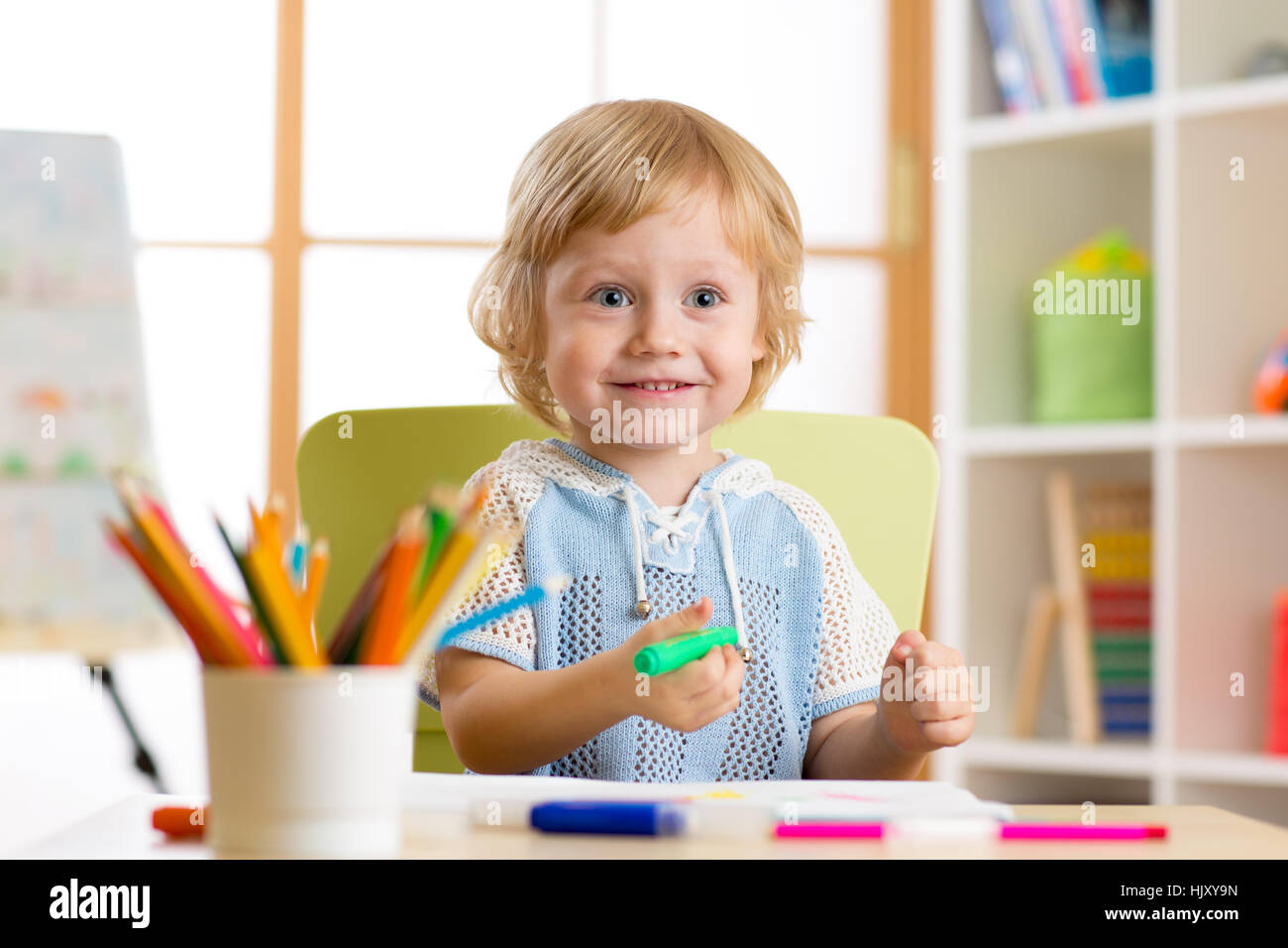 Cute little preschooler child drawing with felt pen at home Stock Photo ...