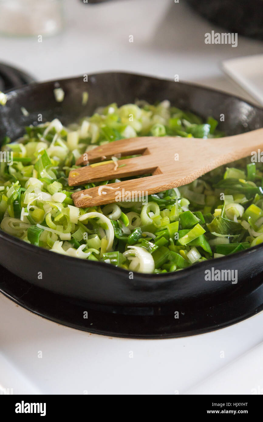 Cooking leeks and onions in a cast iron pan Stock Photo Alamy