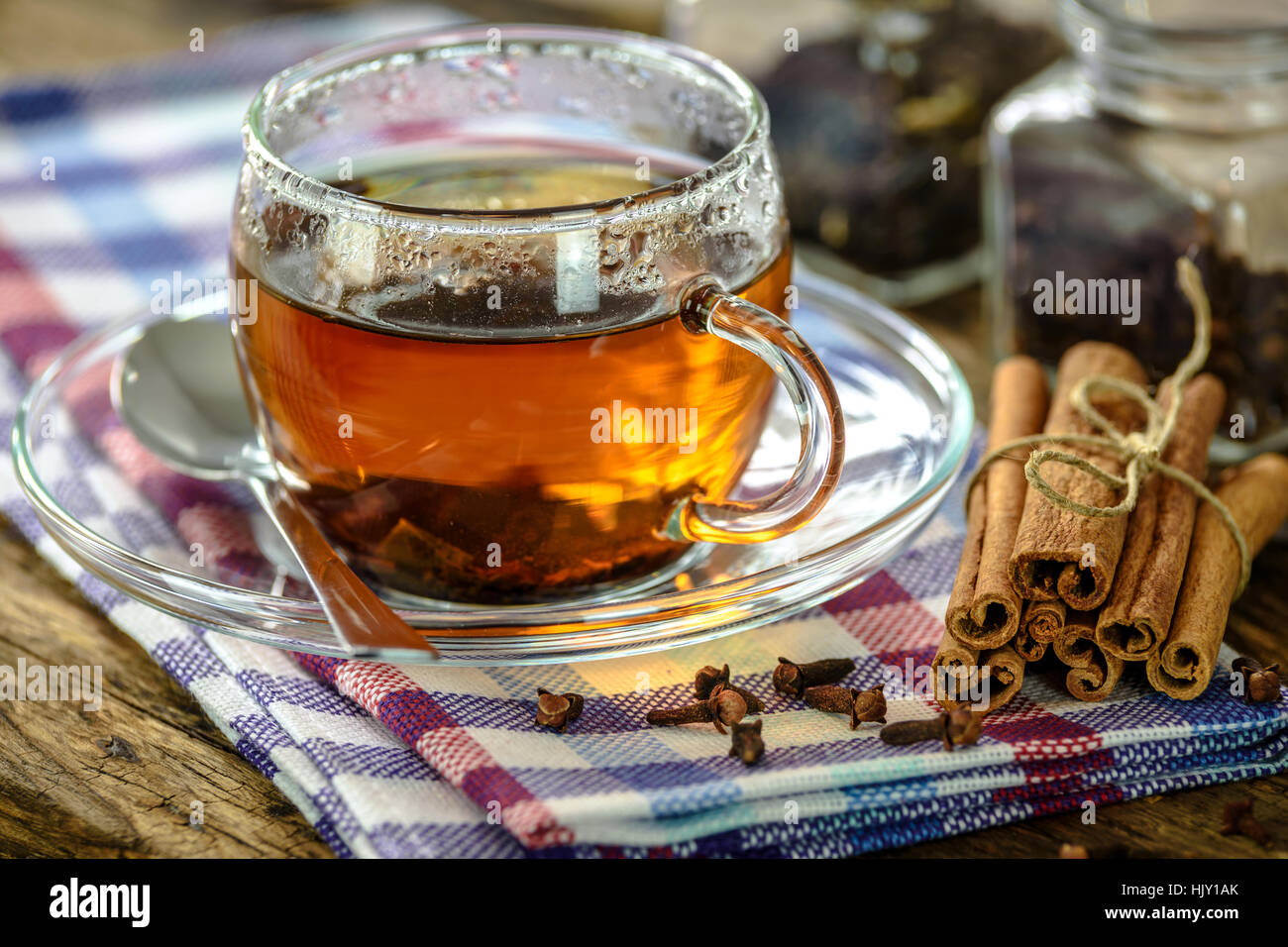Natural and aromatic cup of tea with cinnamon and cloves in vintage style Stock Photo