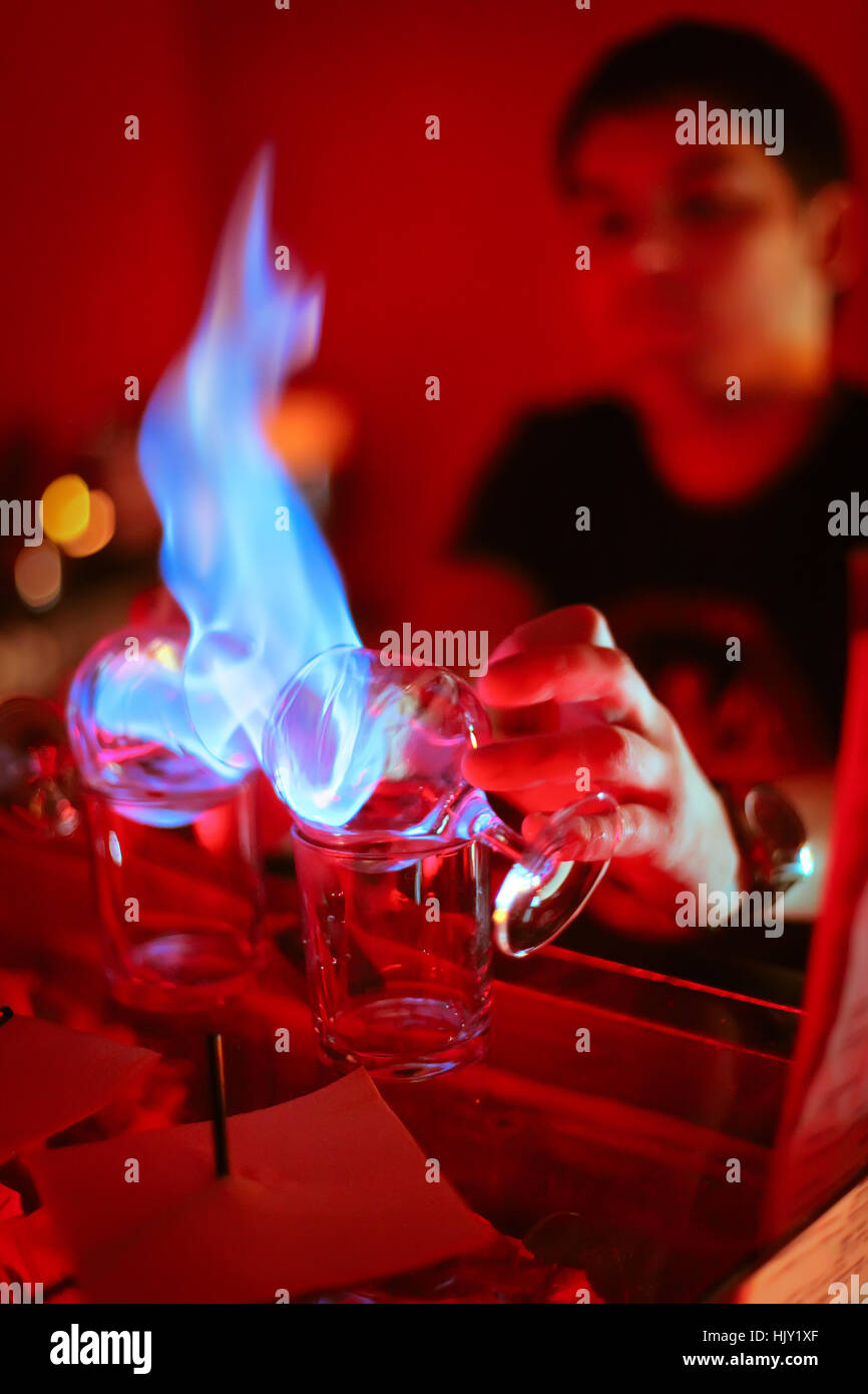 bartender burning Sambuca at the bar Stock Photo