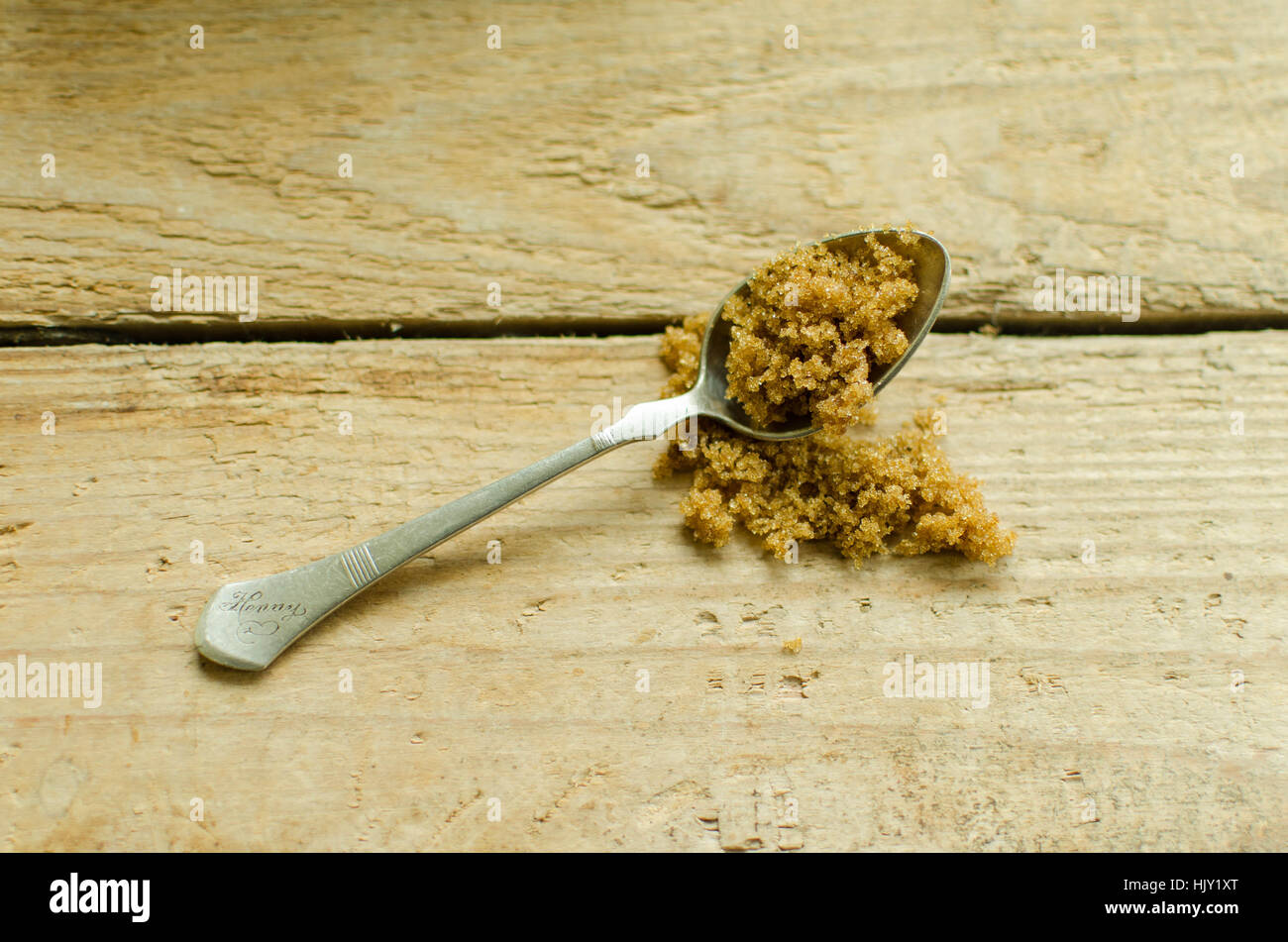 brown sugar and silver spoon on a wooden countertop Stock Photo Alamy