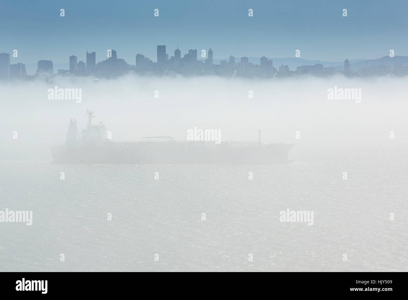 Large Cargo Ship Leaving San Francisco In Thick Fog. Stock Photo