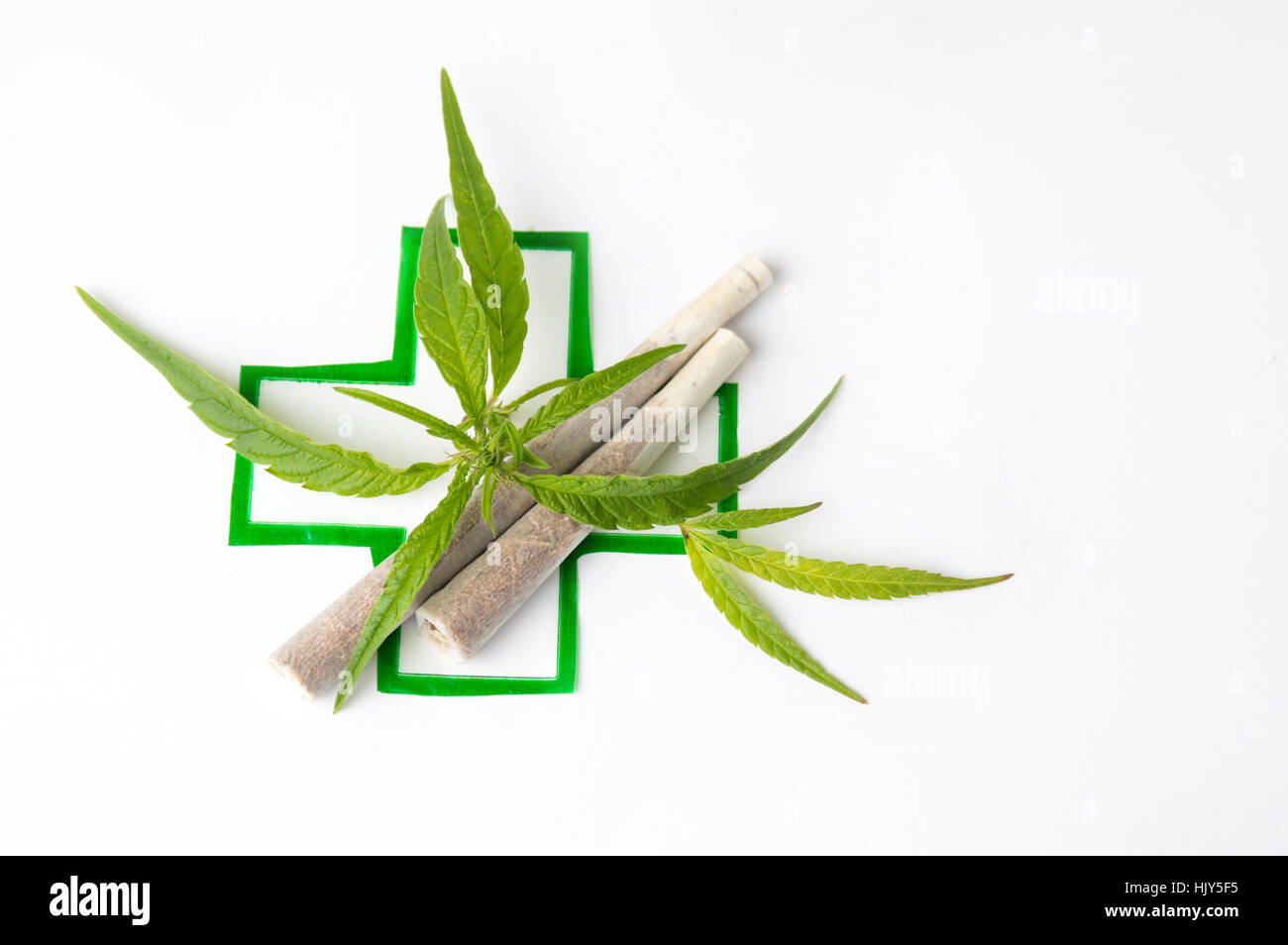 Two joints with marijuana leaves and medical sign Stock Photo