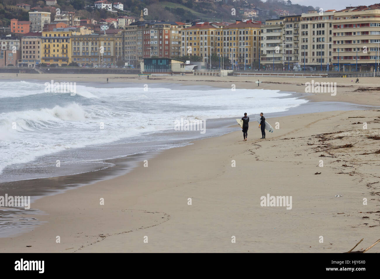 Two surfers at the shore (Donostia, 2017). Stock Photo