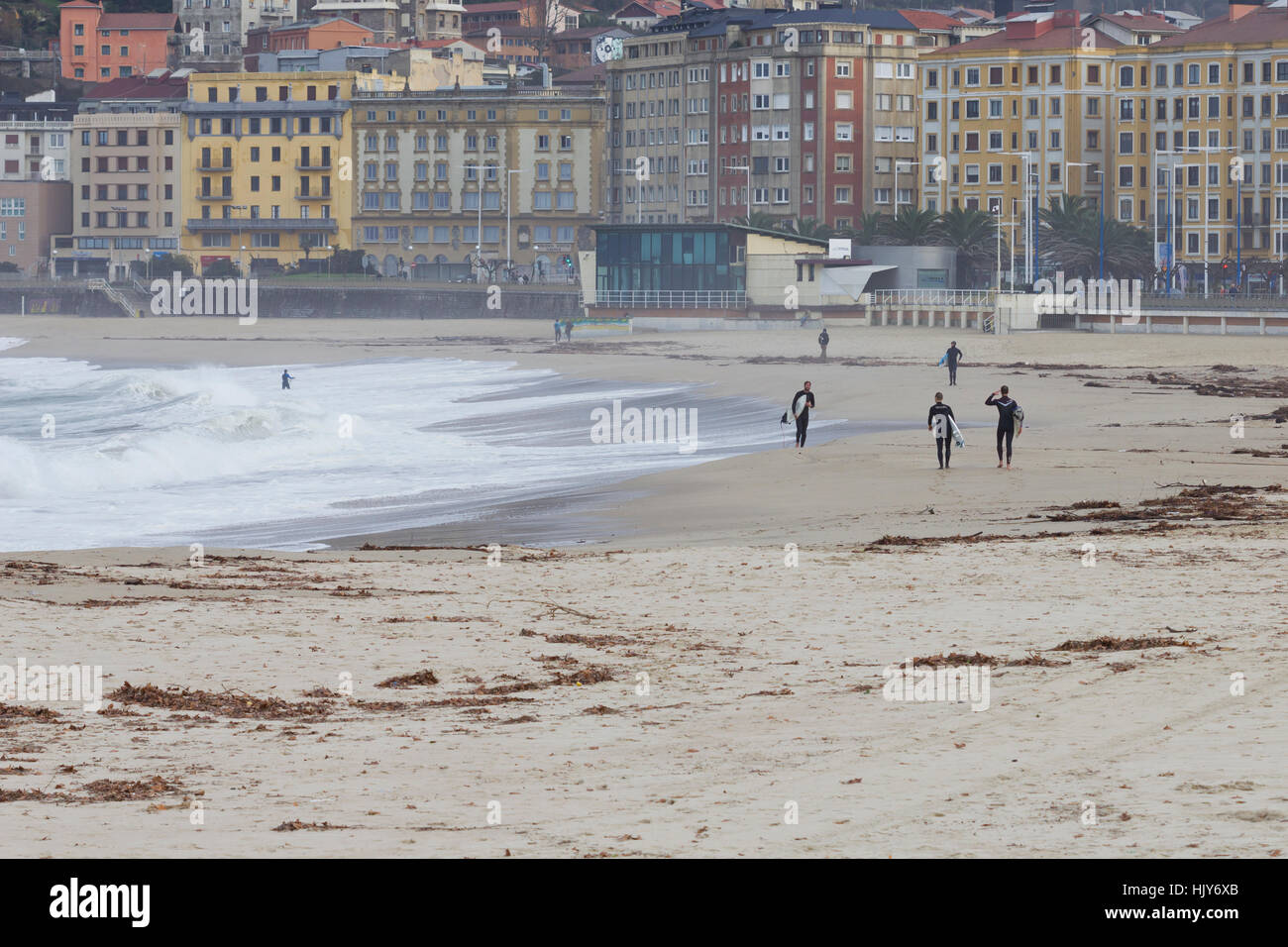 Surfers at the shore looking for waves (Donostia, 2017). Stock Photo