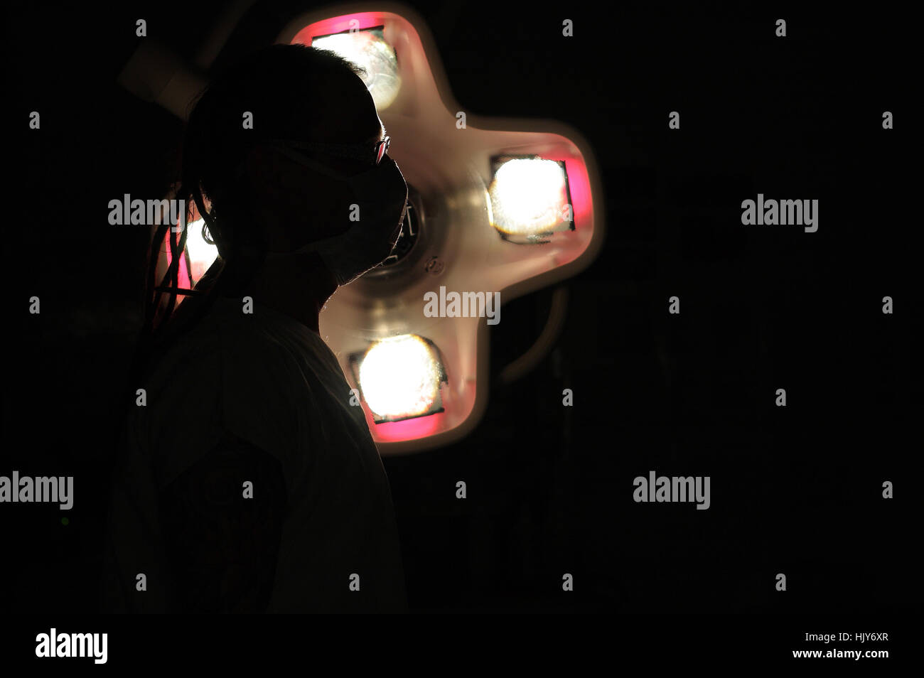 Silhouette of male nurse ICU with dreadlocks on black background with