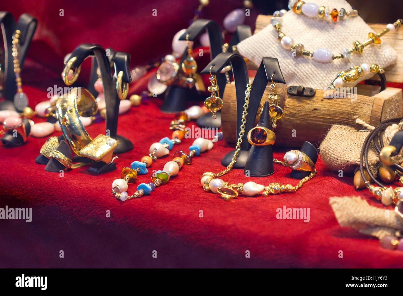 Golden jewelry on a red counter. Stock Photo