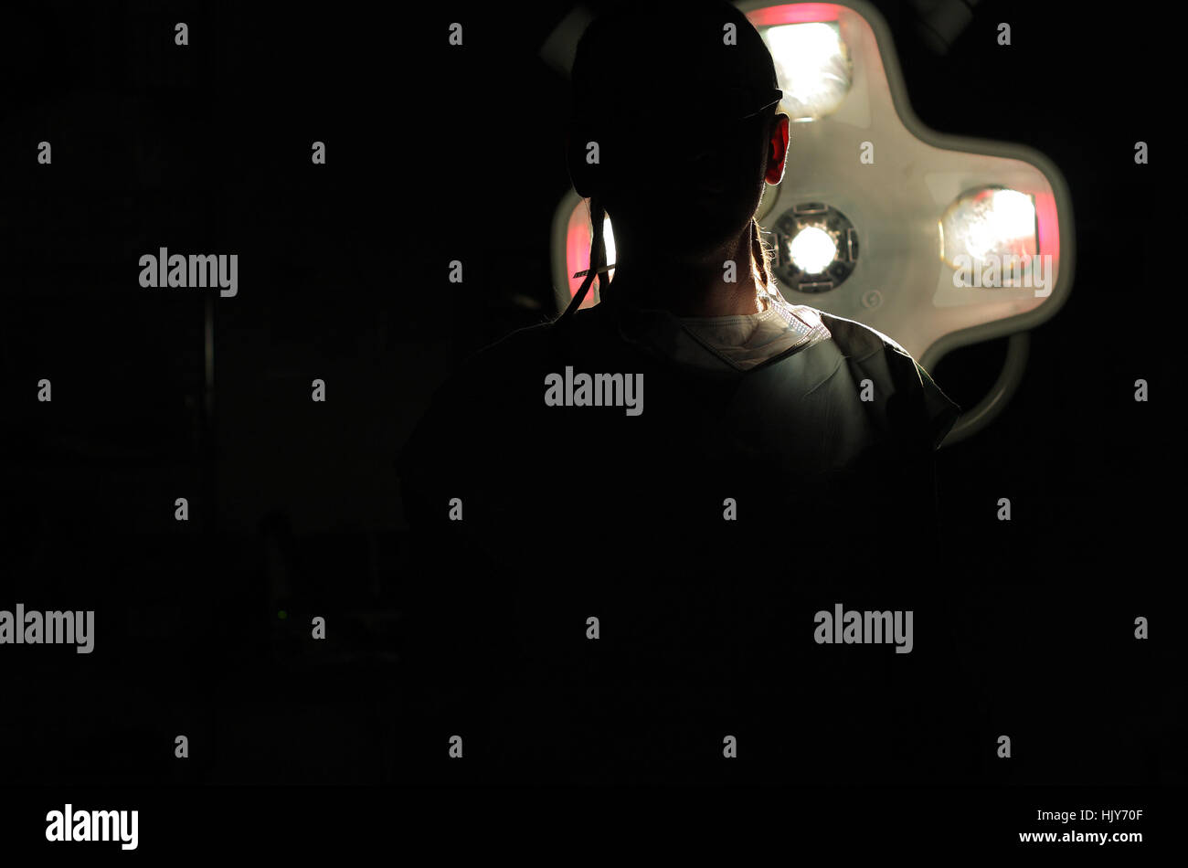 Silhouette of male nurse ICU with dreadlocks on black background with