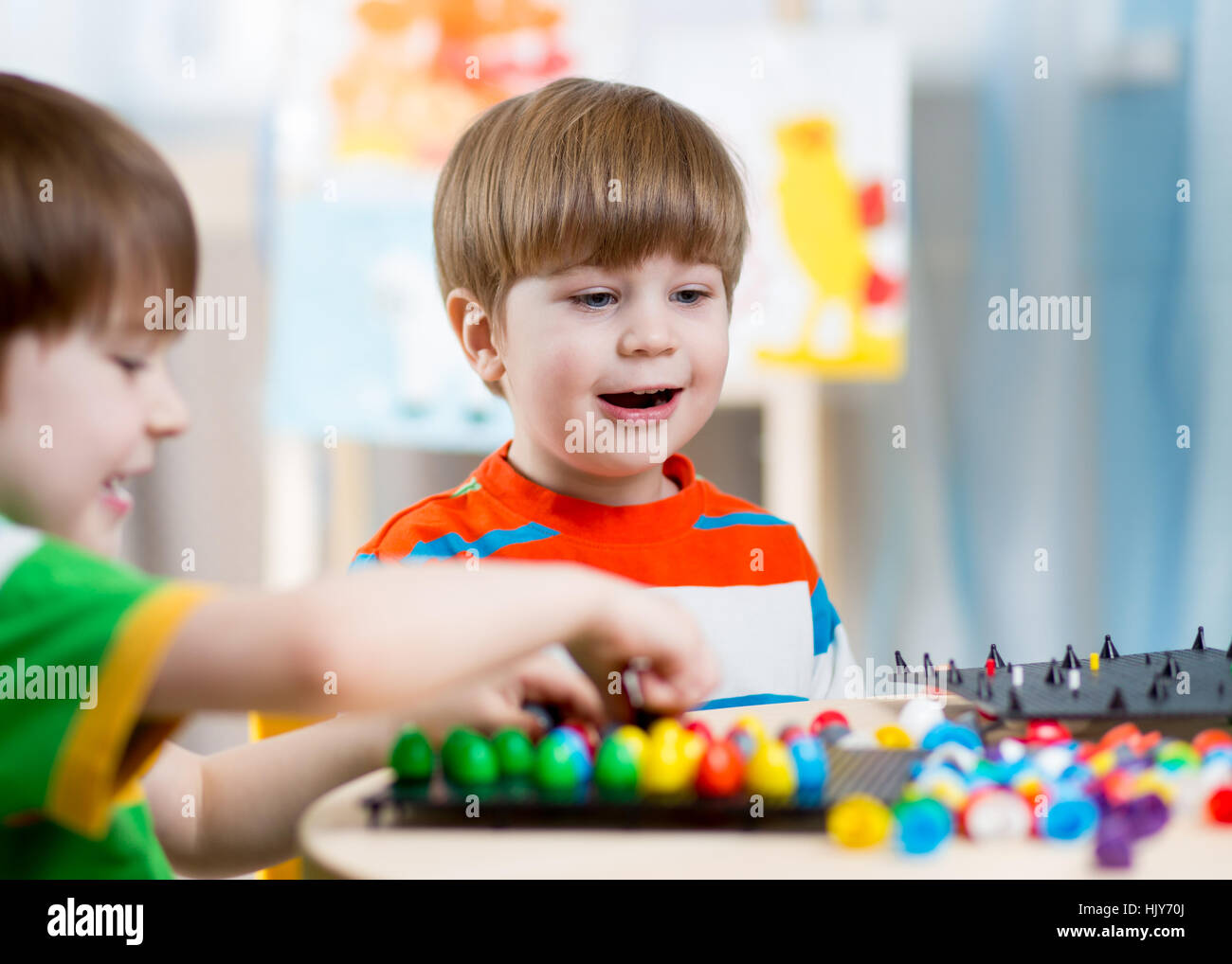 kids children playing mosaic game in kindergarten room Stock Photo