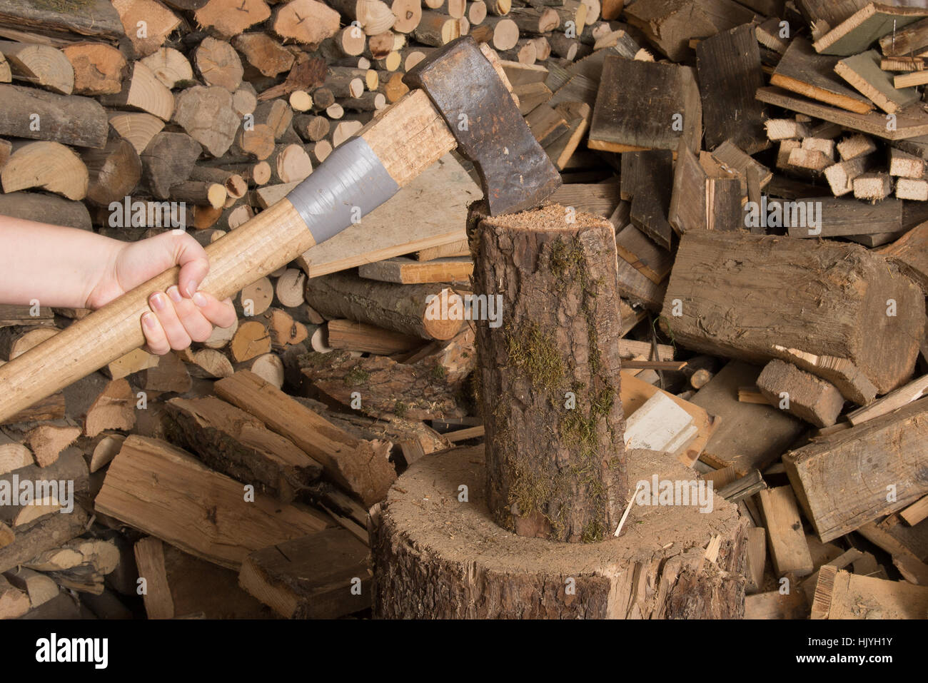 hunk chop wood with an ax,holzscheiter in background Stock Photo