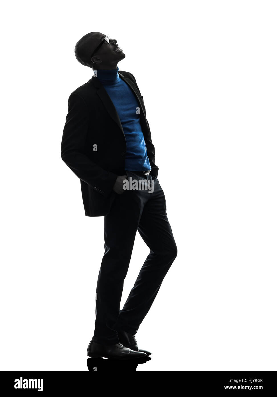 one african black man standing looking up smiling in silhouette studio ...