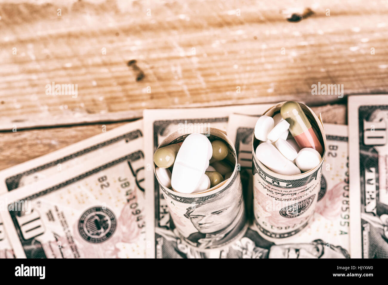pills on dollar bills Stock Photo